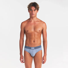 SKIMS COTTON MENS BRIEF 3-PACK | NIMBUS MULTI ON A MODEL FRONT VIEW @ | FOCUS: 0.0, 1.0, 0.9