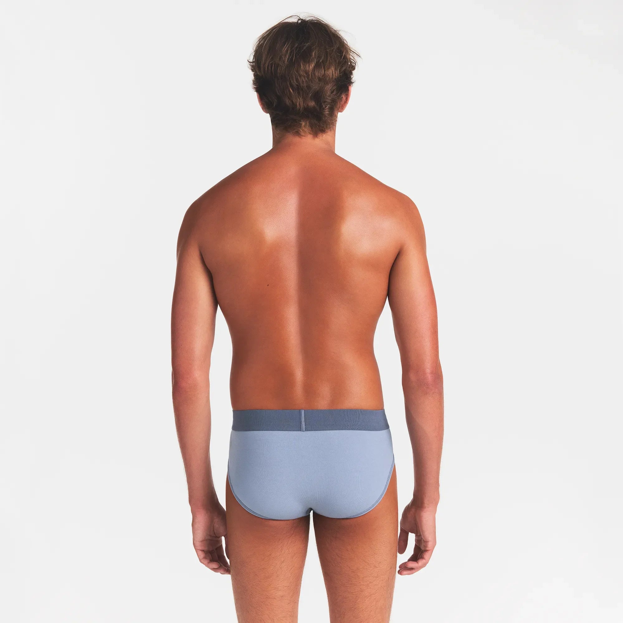 SKIMS COTTON MENS BRIEF 3-PACK | NIMBUS MULTI ON A MODEL BACK VIEW @ | FOCUS: 0.0, 1.0, 0.9