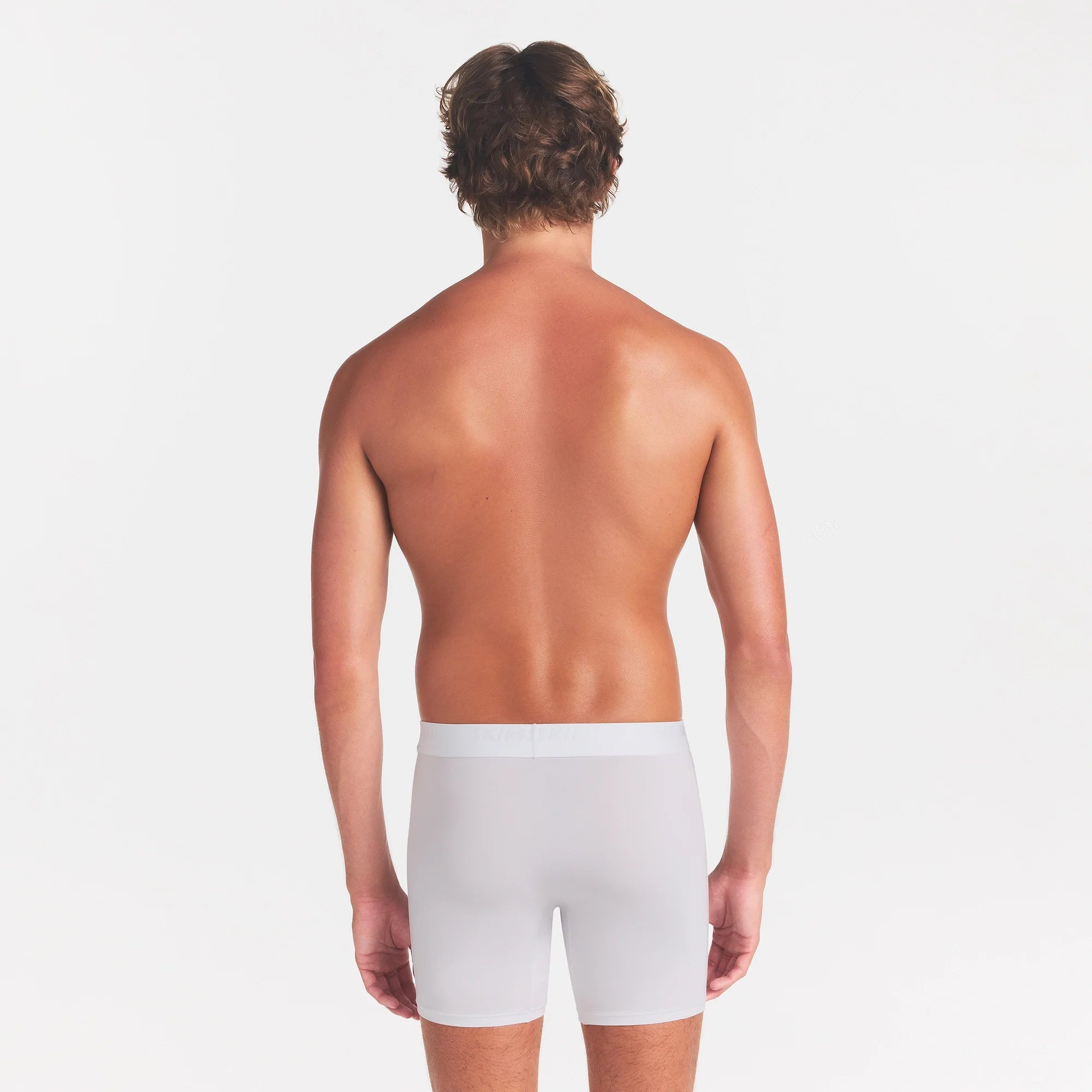 SKIMS STRETCH MENS 3" BOXER BRIEF | CHALK ON A MODEL BACK VIEW