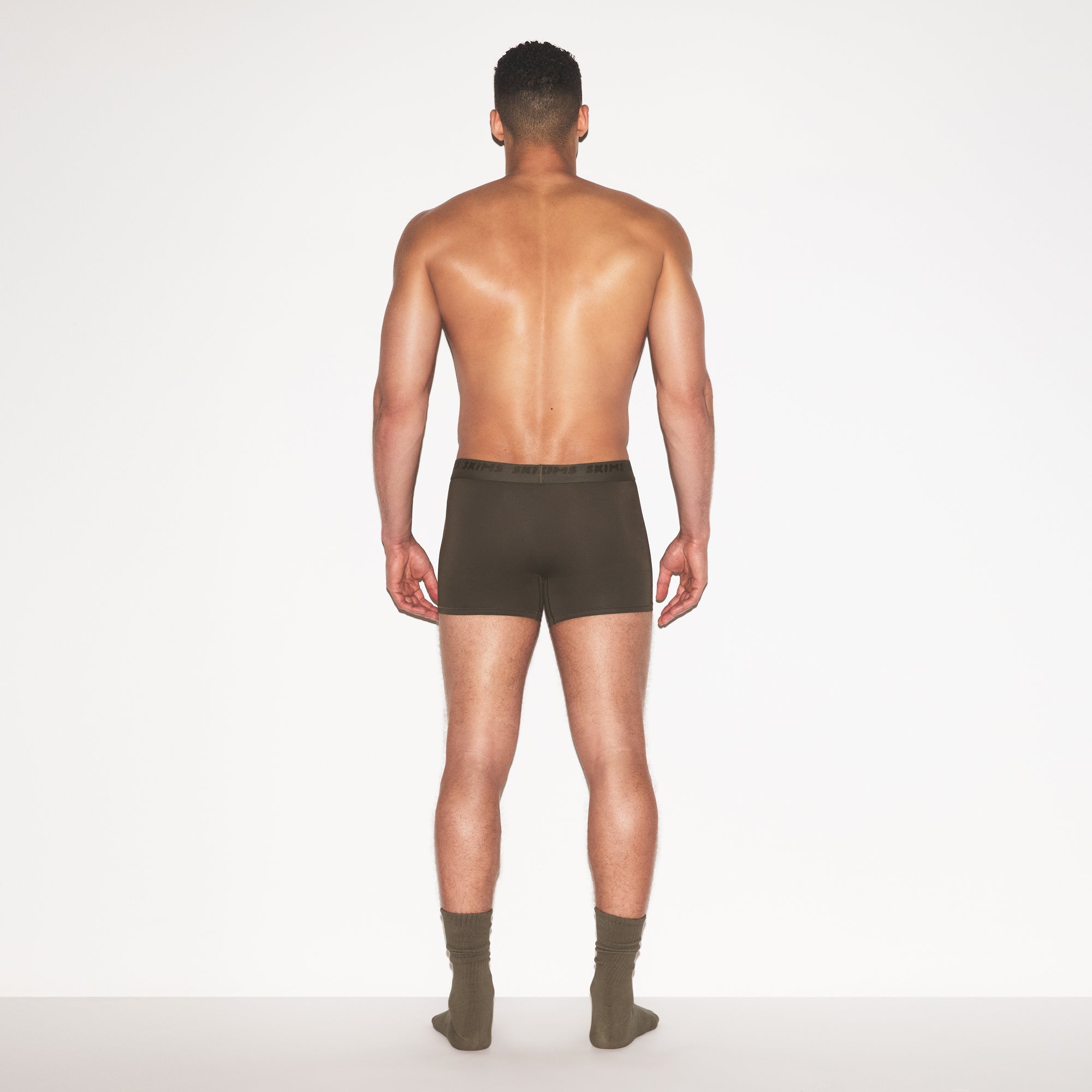 SKIMS STRETCH MENS 3 INCH BOXER BRIEF | LODEN ON A MODEL FRONT VIEW @ | FOCUS: 0.0, 1.0, 0.9