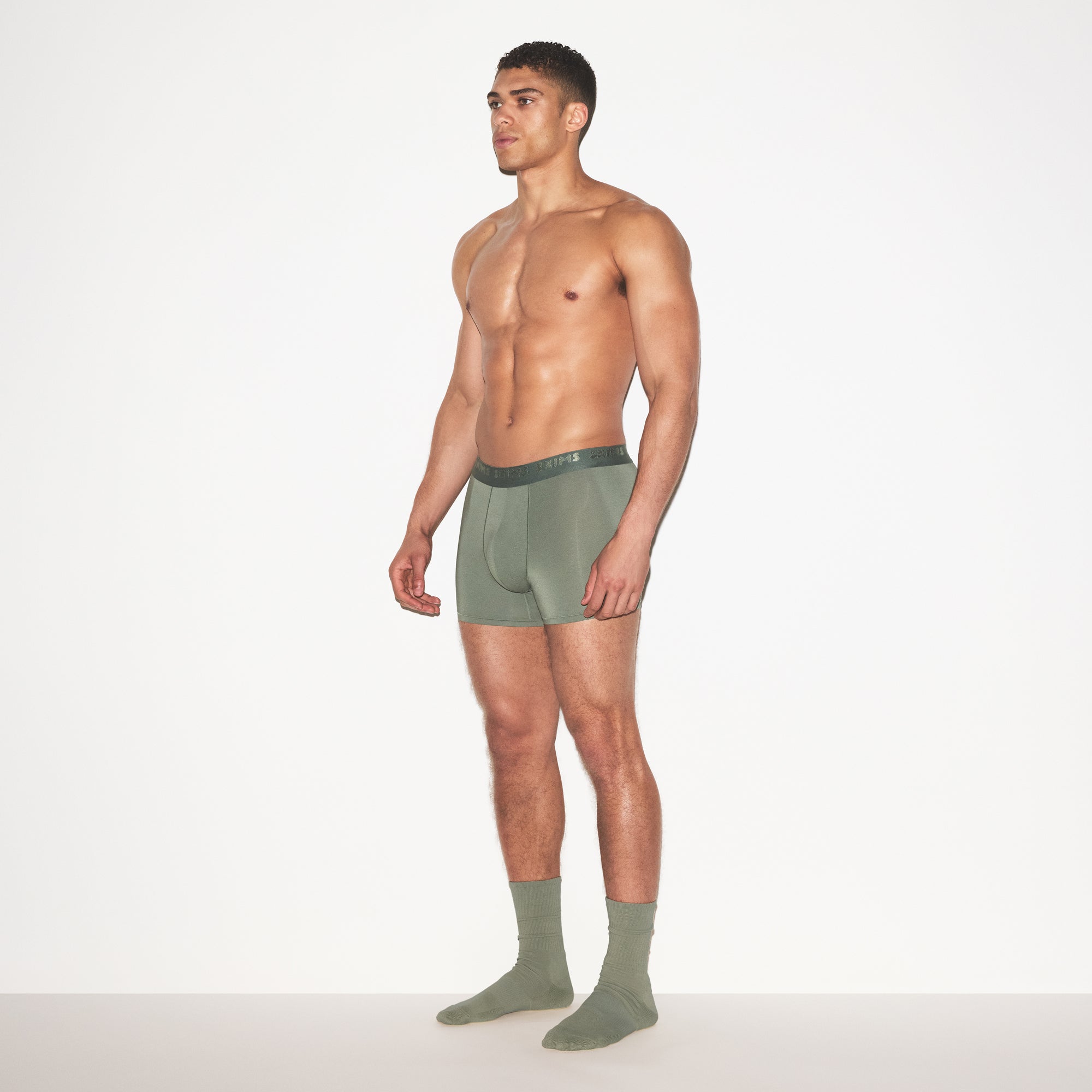 SKIMS STRETCH MENS 3 INCH BOXER BRIEF | LAUREL ON A MODEL FRONT VIEW | FOCUS: 0.0, 1.0, 0.9