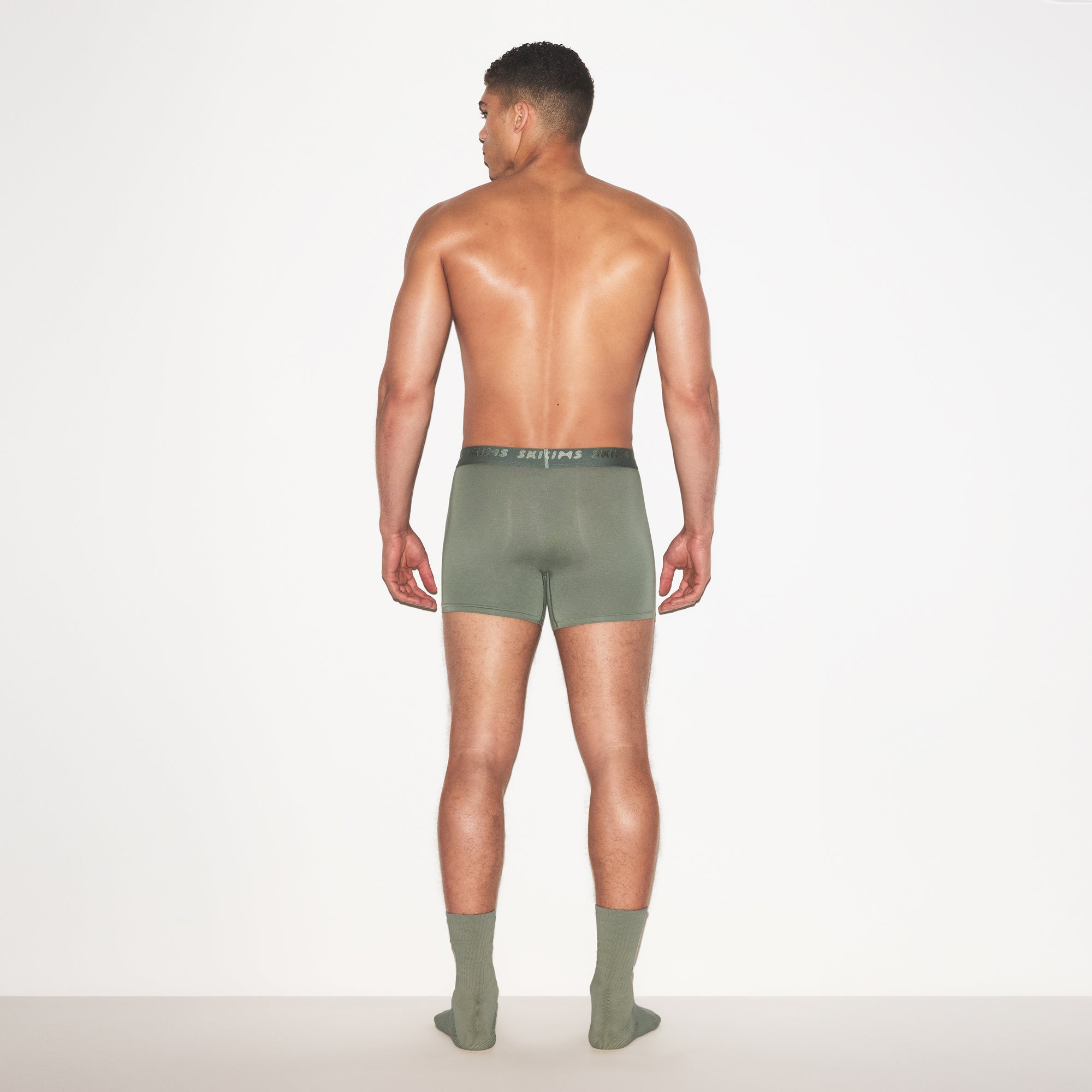 SKIMS STRETCH MENS 3 INCH BOXER BRIEF | LAUREL ON A MODEL FRONT VIEW | FOCUS: 0.0, 1.0, 0.9