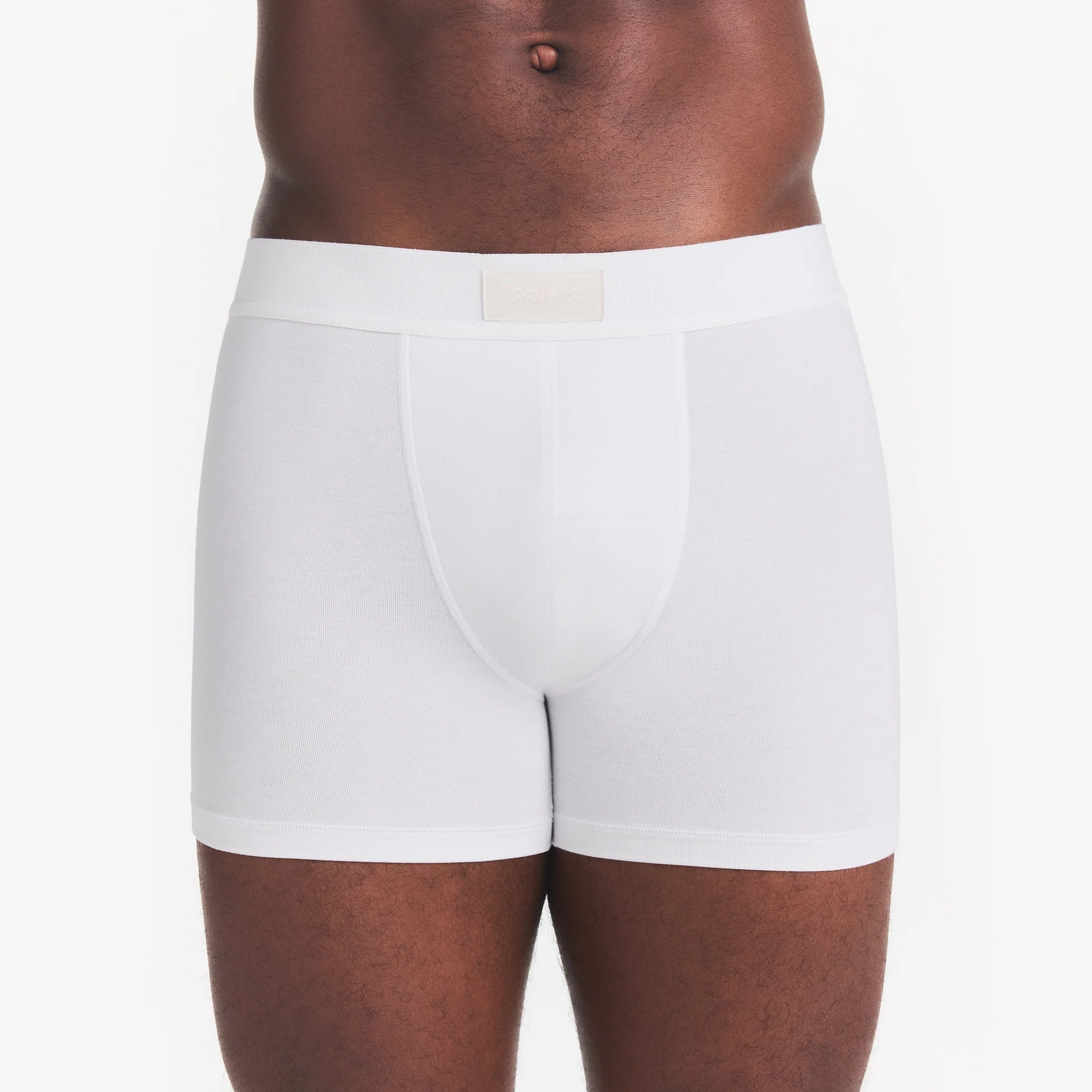 SKIMS COTTON MENS 3" BOXER BRIEF | CHALK ON A MODEL FRONT VIEW