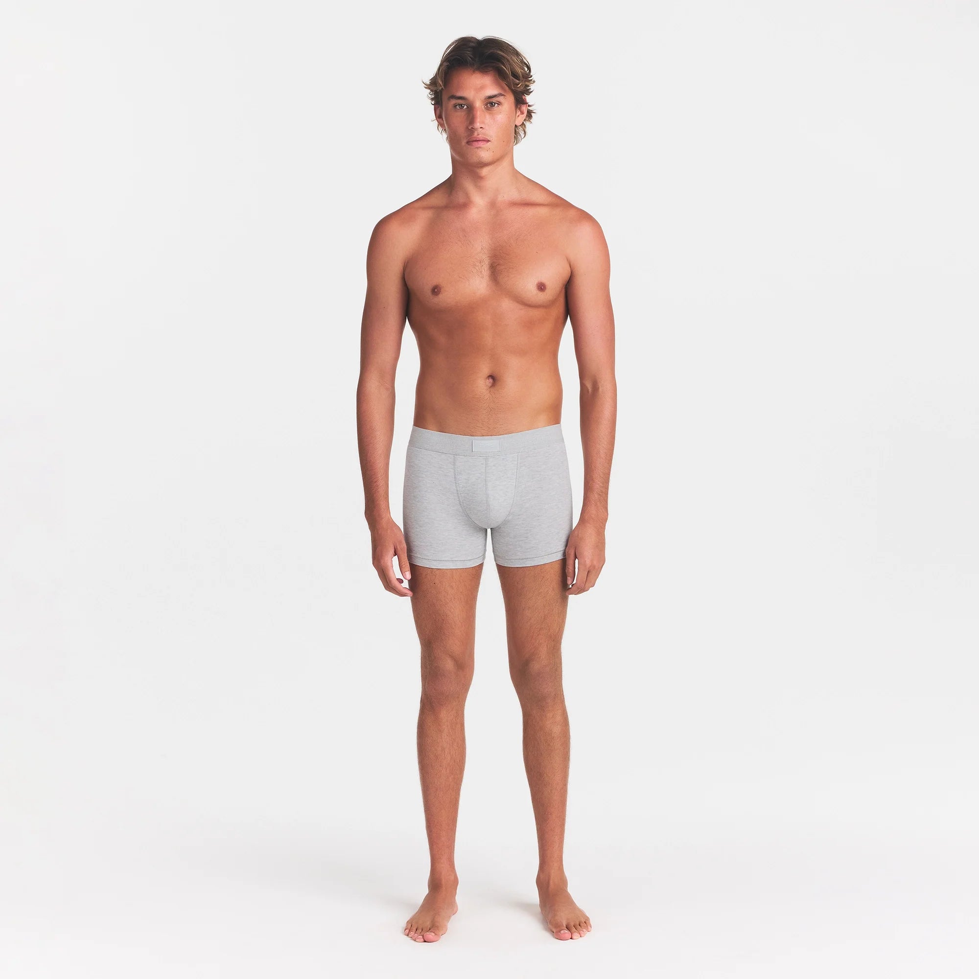 SKIMS COTTON MENS 3" BOXER BRIEF | LIGHT HEATHER GREY ON A MODEL FRONT VIEW @ | FOCUS: 0.0, 1.0, 0.9