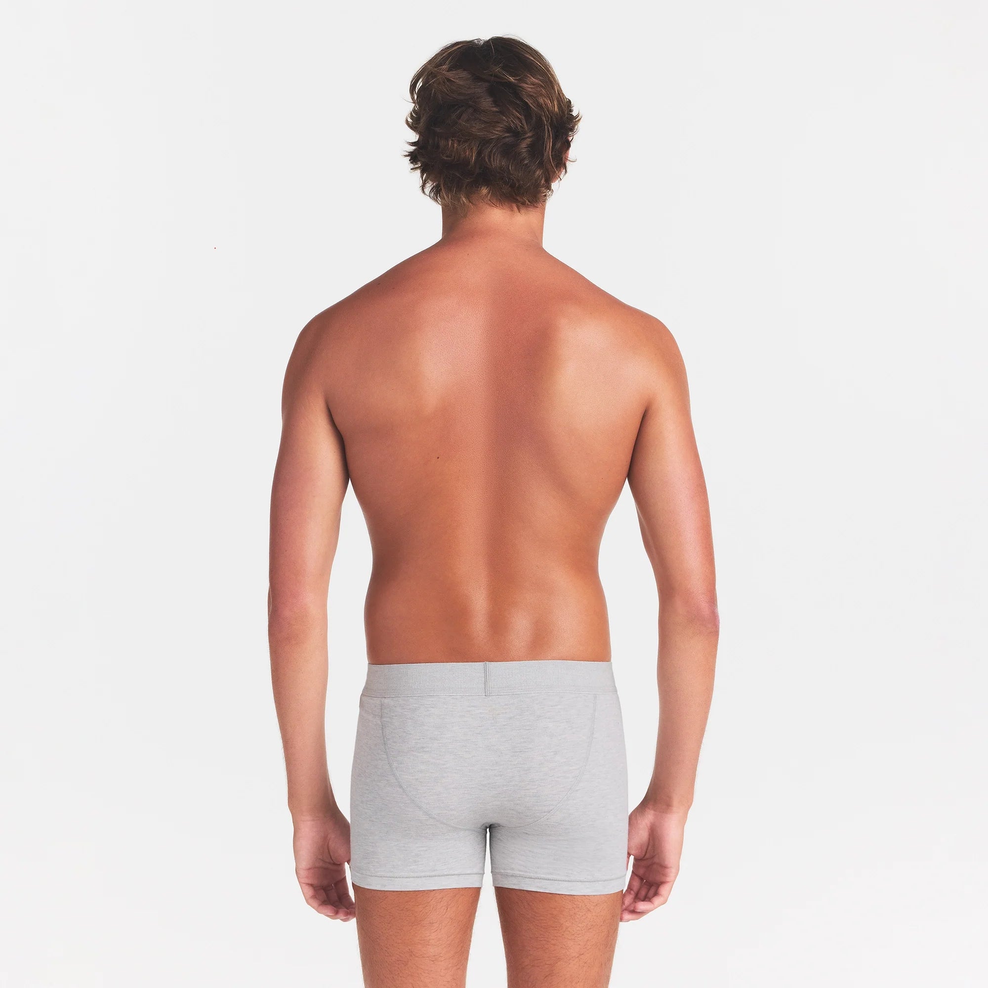 SKIMS COTTON MENS 3" BOXER BRIEF | LIGHT HEATHER GREY ON A MODEL BACK VIEW @ | FOCUS: 0.0, 1.0, 0.9