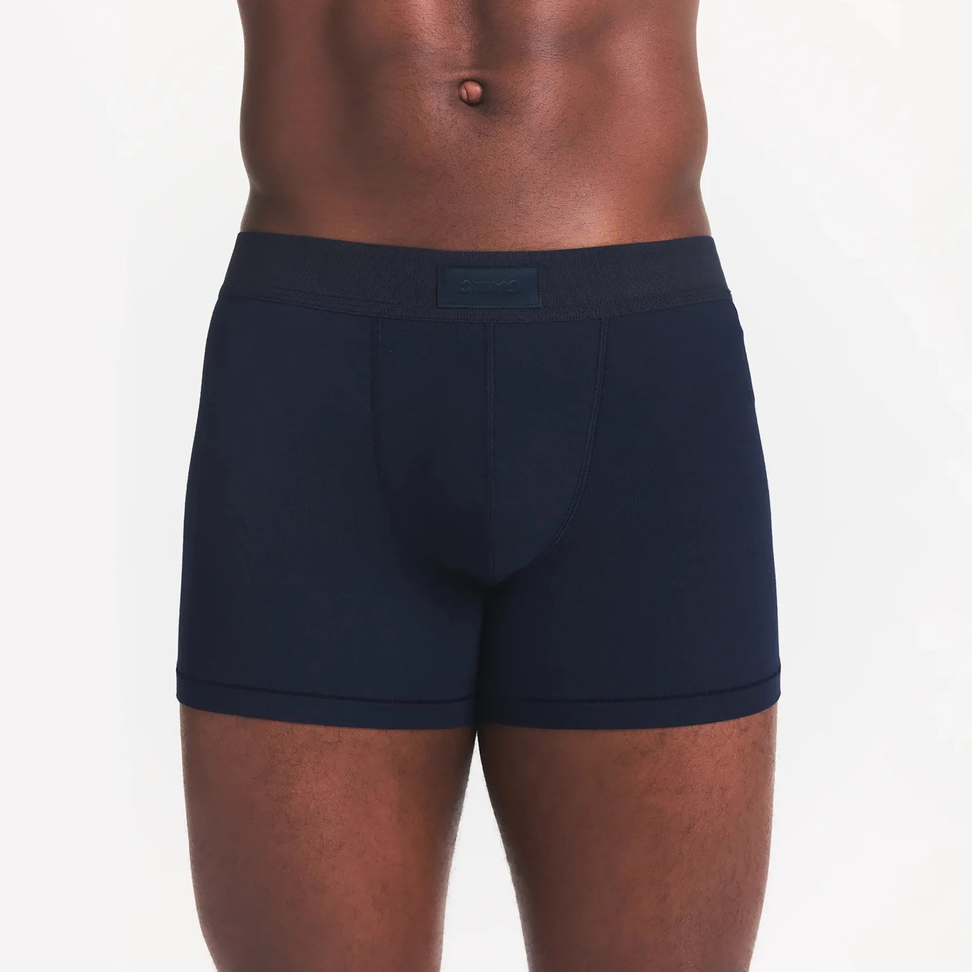 SKIMS COTTON MENS 3" BOXER BRIEF | NAVY ON A MODEL FRONT VIEW
