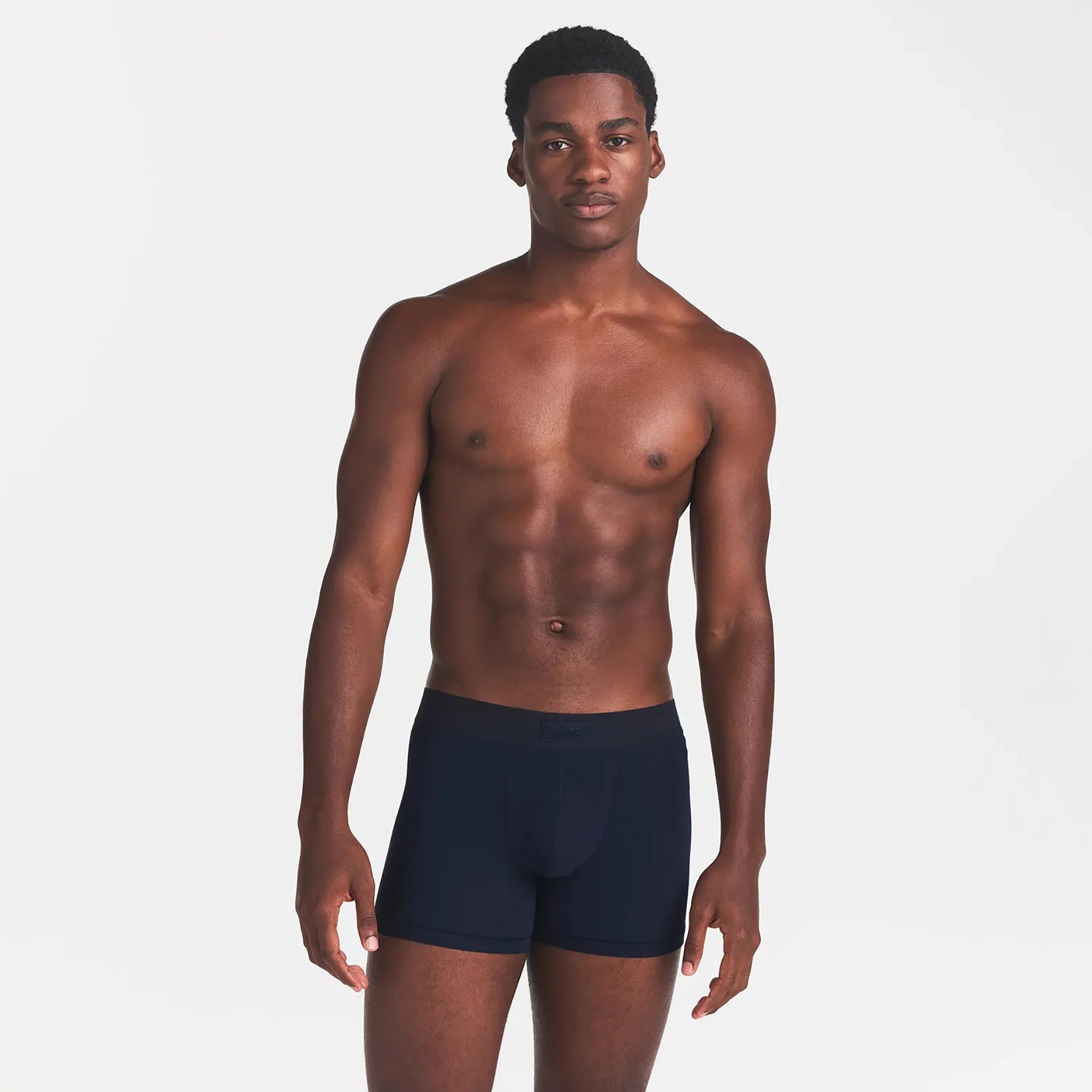 SKIMS COTTON MENS 3" BOXER BRIEF | NAVY ON A MODEL FRONT VIEW