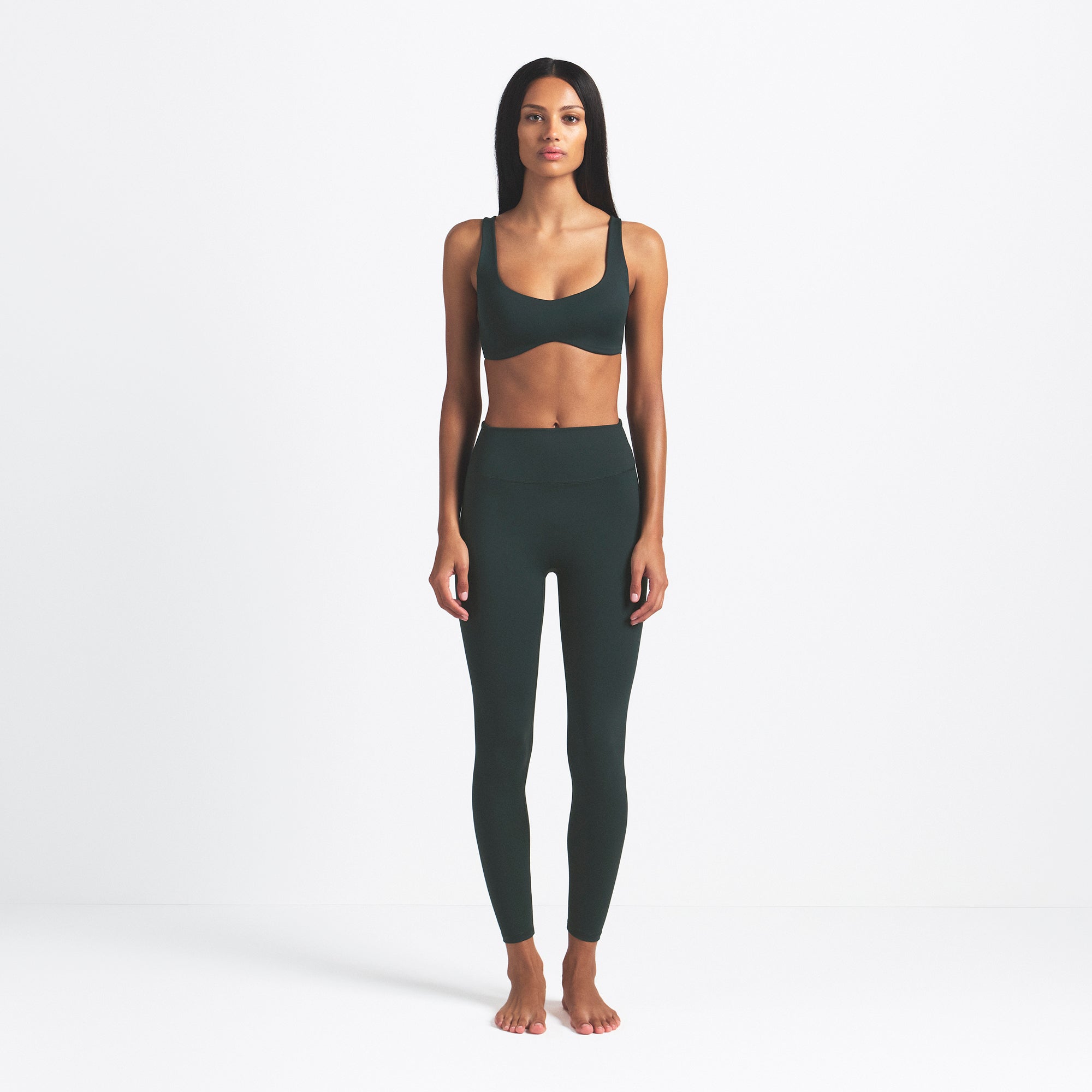 NikeSKIMS MATTE 26" LEGGING | DARK TEAL ON A MODEL FRONT VIEW @ | FOCUS: 0.0, 1.0, 0.9