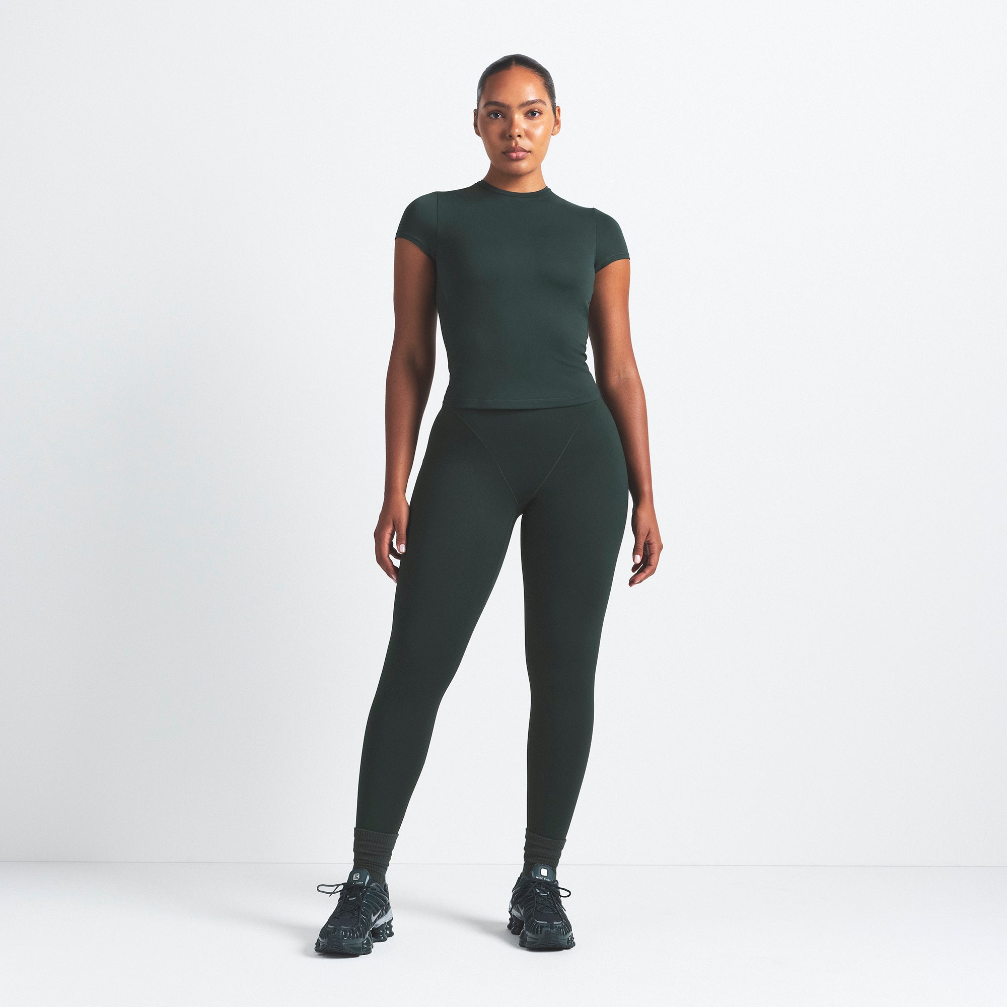 NikeSKIMS MATTE V-LINE 26" LEGGING | DARK TEAL ON A MODEL FRONT VIEW @ | FOCUS: 0.0, 1.0, 0.9