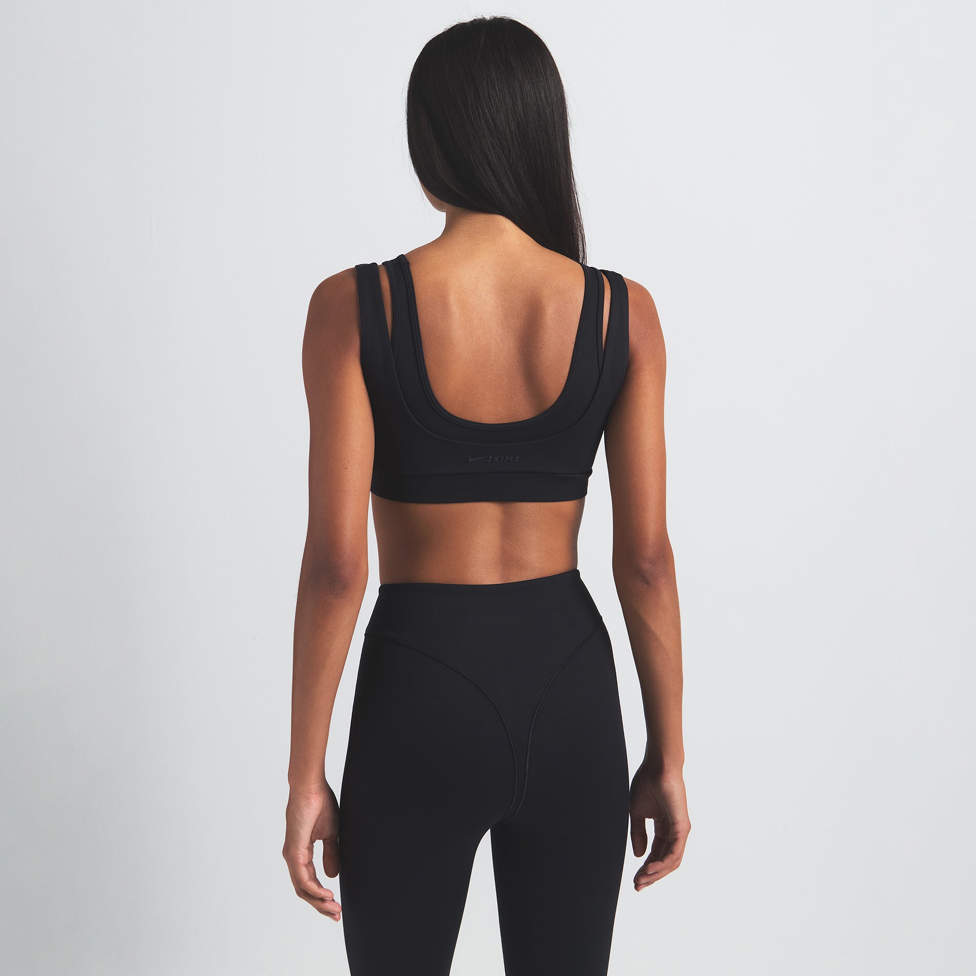 NikeSKIMS MATTE V-LINE 26" LEGGING | OBSIDIAN ON A MODEL BACK VIEW