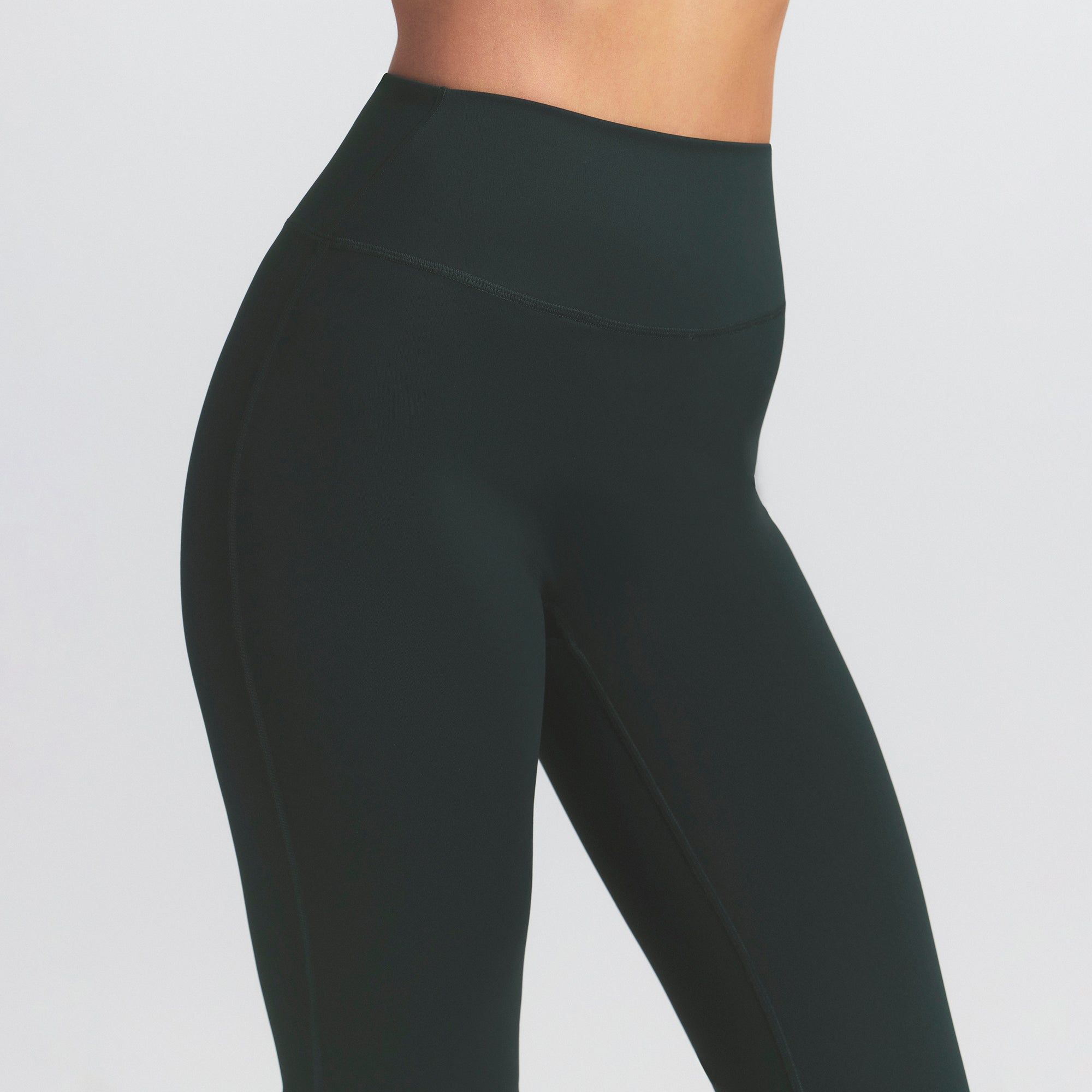 NikeSKIMS MATTE SLIM FLARE LEGGING | DARK TEAL ON A MODEL SIDE VIEW @ | FOCUS: 0.0, 1.0, 0.9
