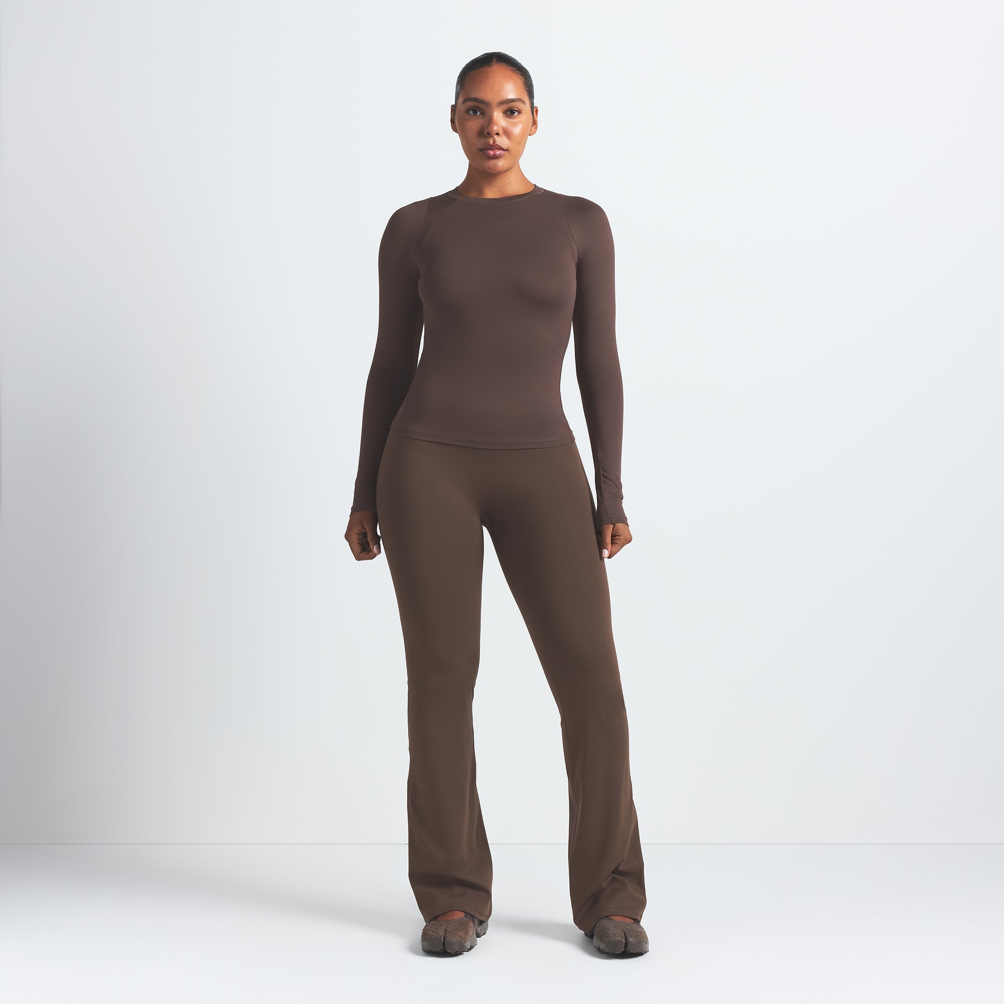 NikeSKIMS MATTE SLIM FLARE LEGGING | DARK SEPIA ON A MODEL FRONT VIEW