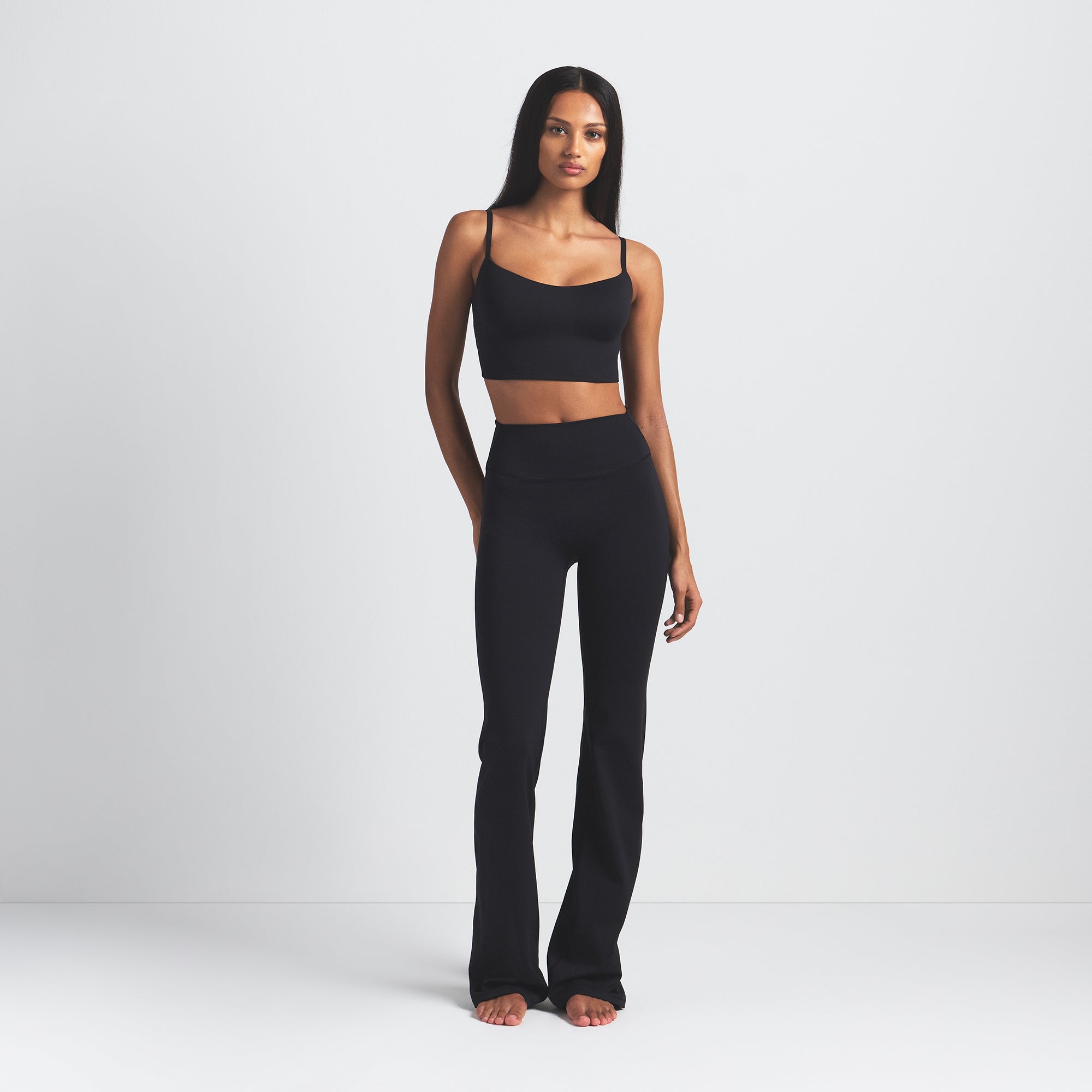 NikeSKIMS MATTE SLIM FLARE LEGGING | OBSIDIAN ON A MODEL FRONT VIEW @ | FOCUS: 0.0, 1.0, 0.9