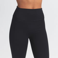 NikeSKIMS MATTE SLIM FLARE LEGGING | OBSIDIAN ON A MODEL FRONT VIEW @ | FOCUS: 0.0, 1.0, 0.9