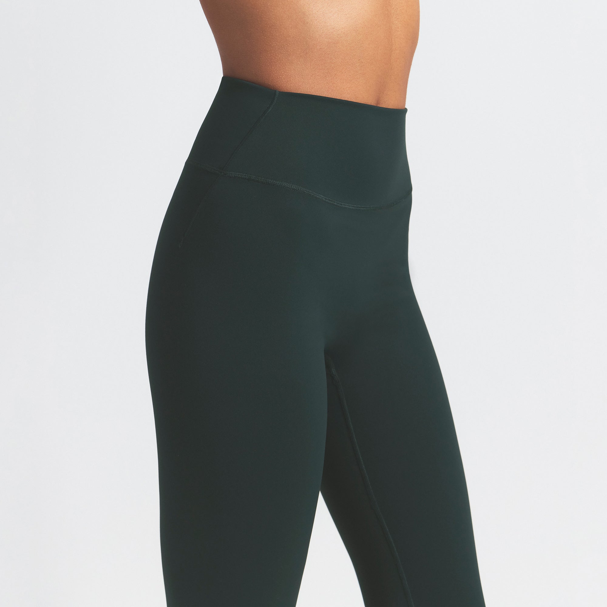 NikeSKIMS MATTE 29" LEGGING | DARK TEAL ON A MODEL SIDE VIEW @ | FOCUS: 0.0, 1.0, 0.9