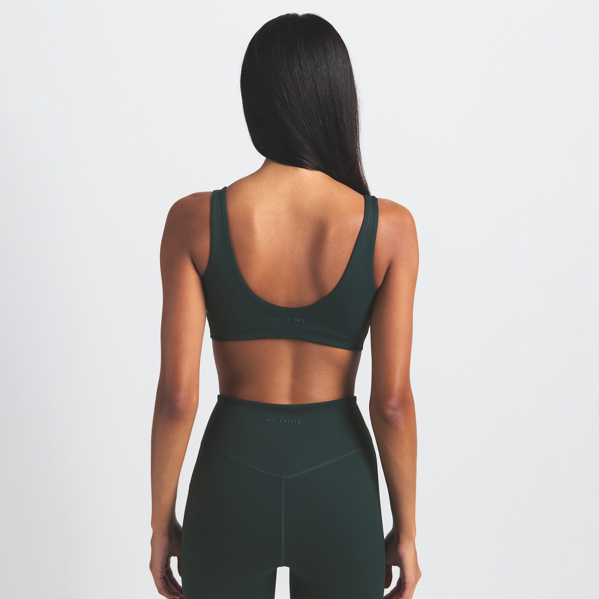 NikeSKIMS MATTE 29" LEGGING | DARK TEAL ON A MODEL SIDE VIEW @ | FOCUS: 0.0, 1.0, 0.9