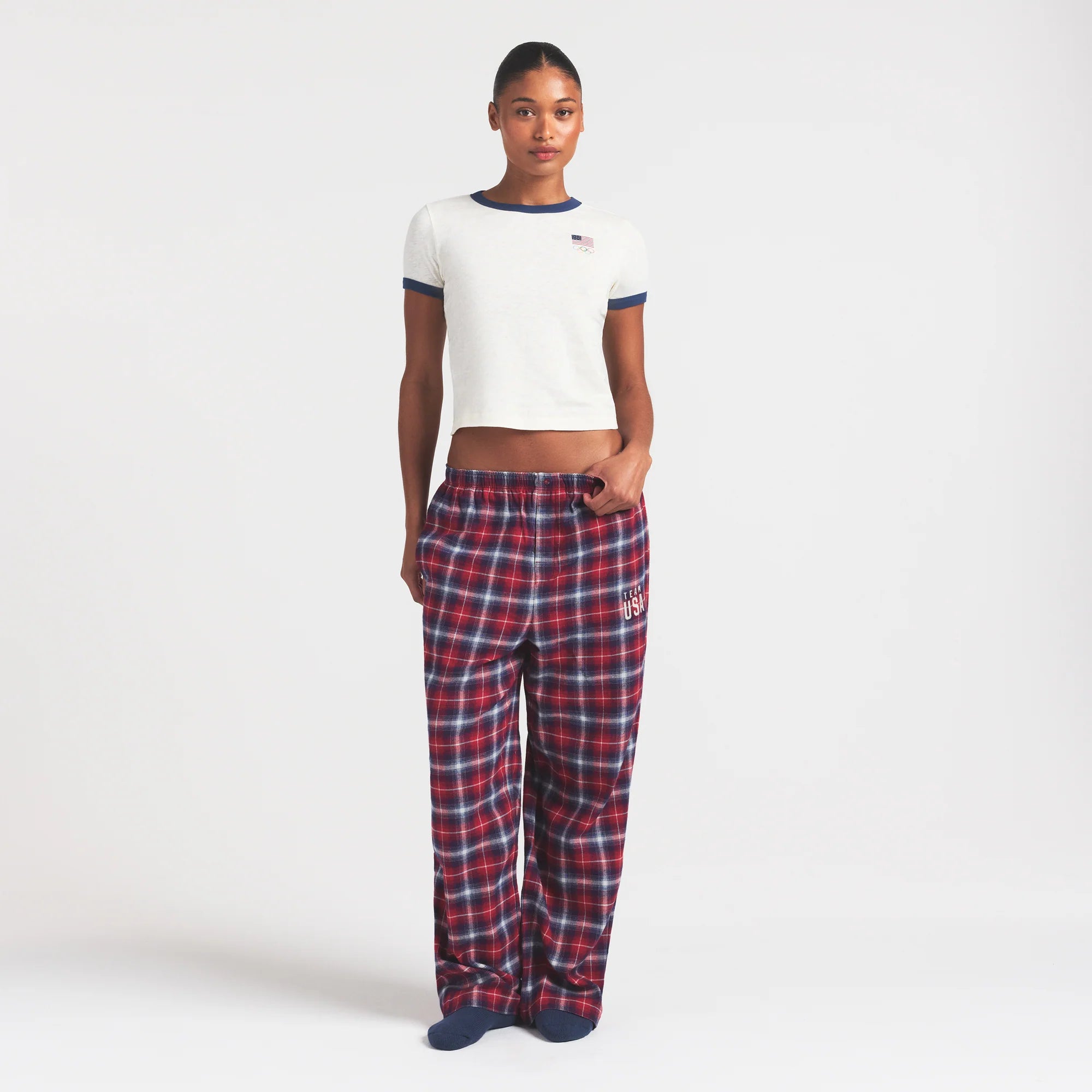 SKIMS FOR TEAM USA FLANNEL SLEEP OLYMPIC PANT | RED PLAID ON A MODEL FRONT VIEW @ | FOCUS: 0.0, 1.0, 0.9