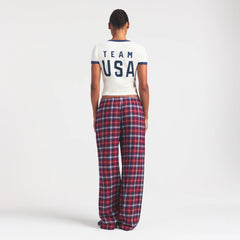SKIMS FOR TEAM USA FLANNEL SLEEP OLYMPIC PANT | RED PLAID ON A MODEL FRONT VIEW @ | FOCUS: 0.0, 1.0, 0.9