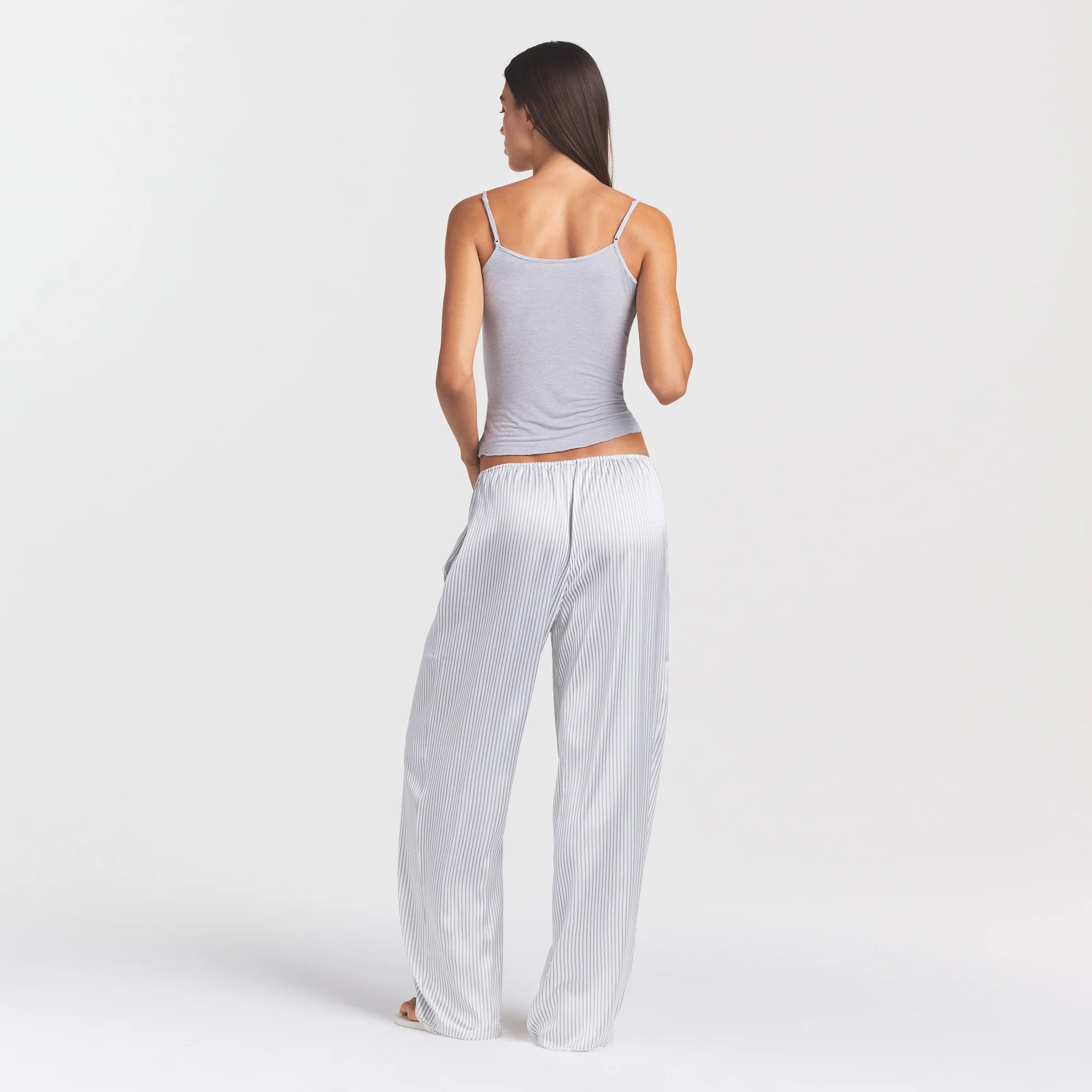 WOVEN SHINE LACE PANT | SILVER TRIPLE PINSTRIPE ON A MODEL SIDE VIEW @ | FOCUS: 0.0, 1.0, 0.9