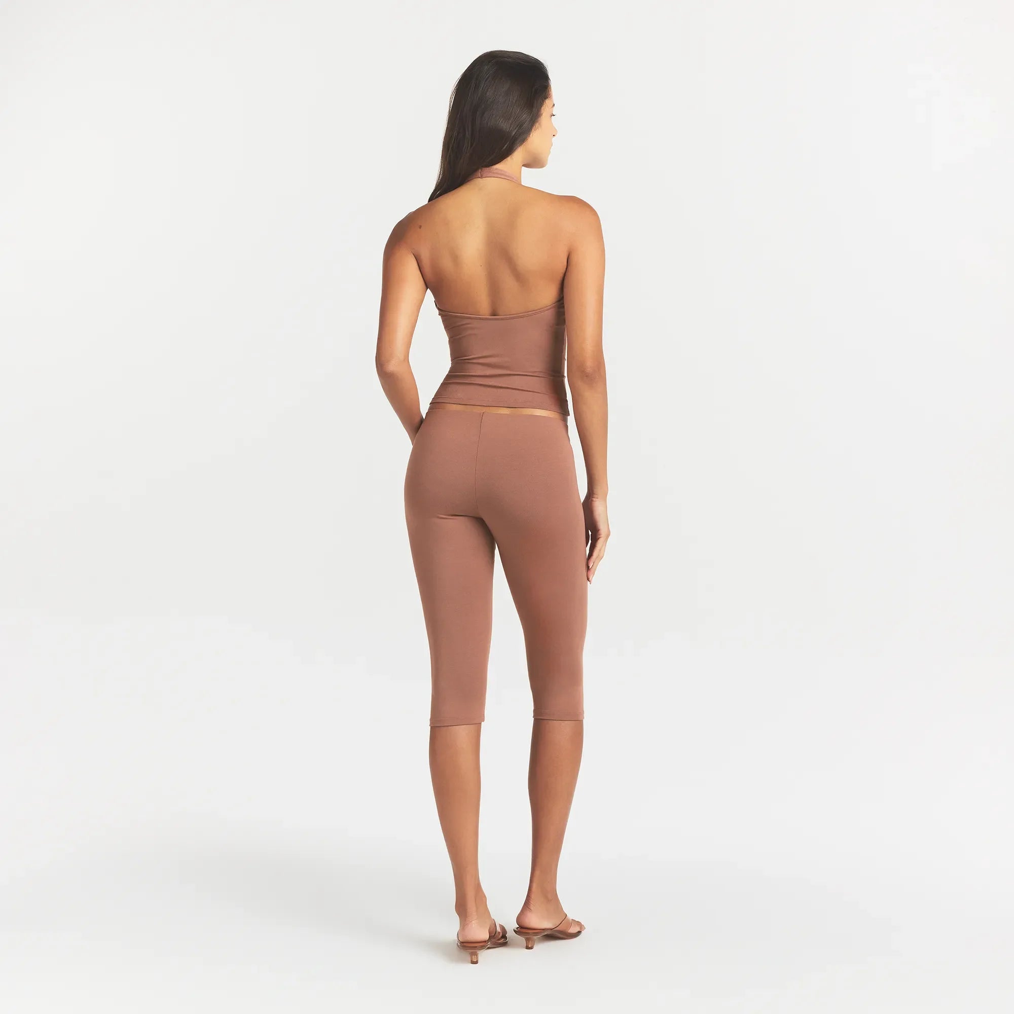 SMOOTH LAYERS HIGH-WAISTED CAPRI | NUTMEG ON A MODEL BACK VIEW @ | FOCUS: 0.0, 1.0, 0.9