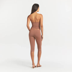 SMOOTH LAYERS HIGH-WAISTED CAPRI | NUTMEG ON A MODEL BACK VIEW @ | FOCUS: 0.0, 1.0, 0.9