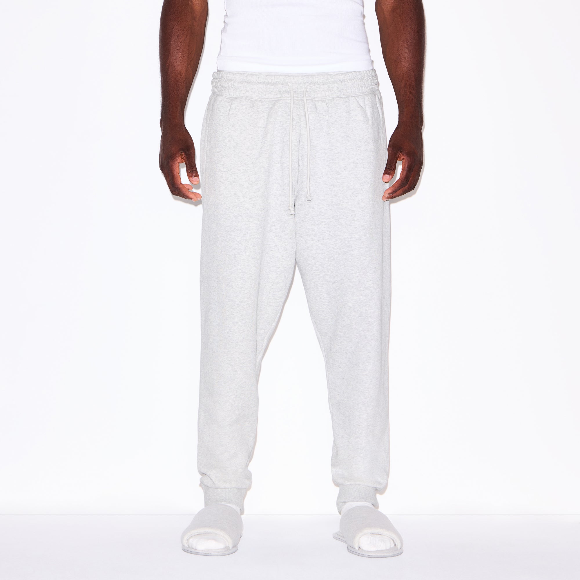 FLEECE LOUNGE MENS TAPERED JOGGER | LIGHT HEATHER GREY ON A MODEL SIDE VIEW @ | FOCUS: 0.0, 1.0, 0.9