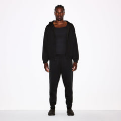 FLEECE LOUNGE MENS TAPERED JOGGER | WASHED ONYX ON A MODEL FRONT VIEW @ | FOCUS: 0.0, 1.0, 0.9