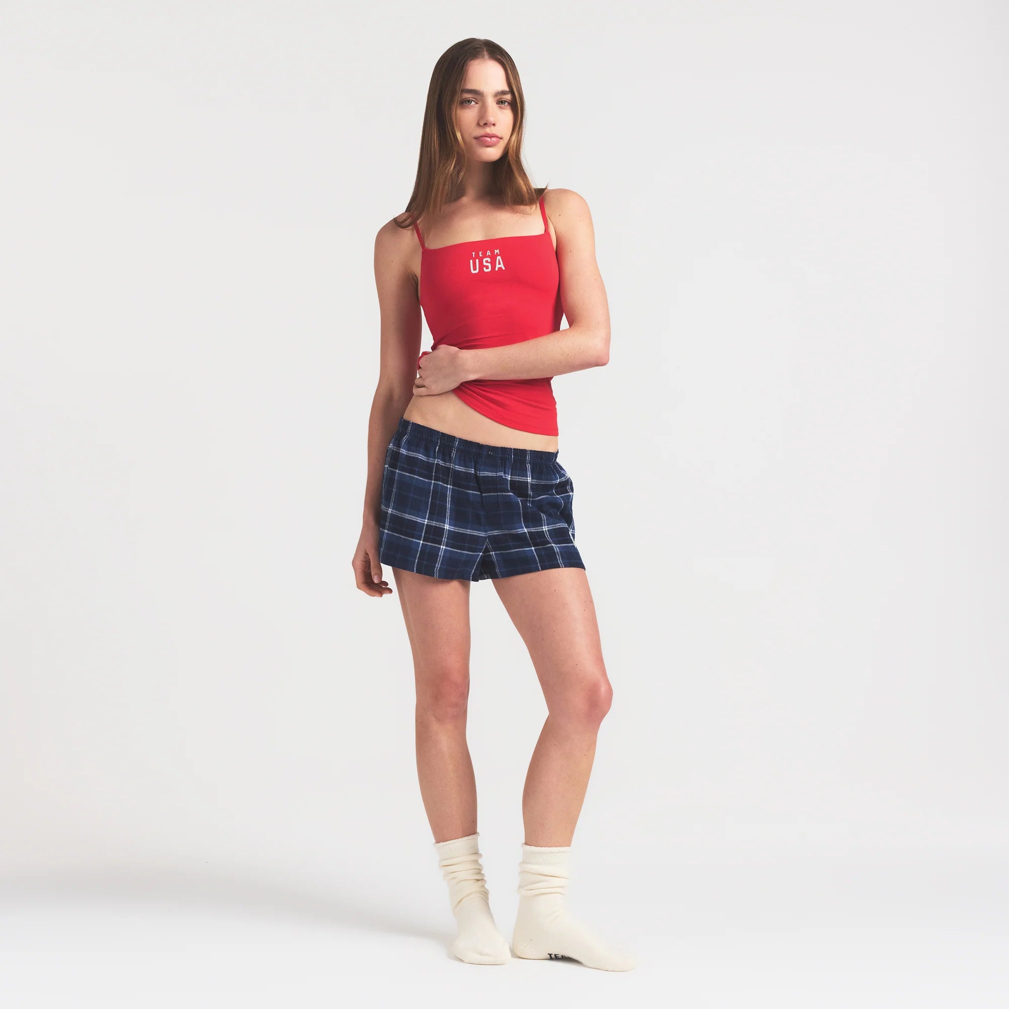 SKIMS FOR TEAM USA FLANNEL SLEEP OLYMPIC SHORT | NAVY PLAID ON A MODEL FRONT VIEW @ | FOCUS: 0.0, 1.0, 0.9
