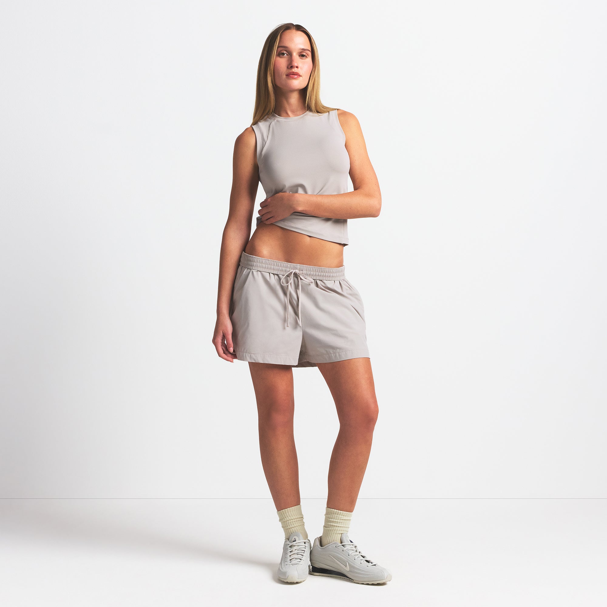 NikeSKIMS WOVEN NYLON 5" TRACK SHORT | STONE ON A MODEL FRONT VIEW @ | FOCUS: 0.0, 1.0, 0.9