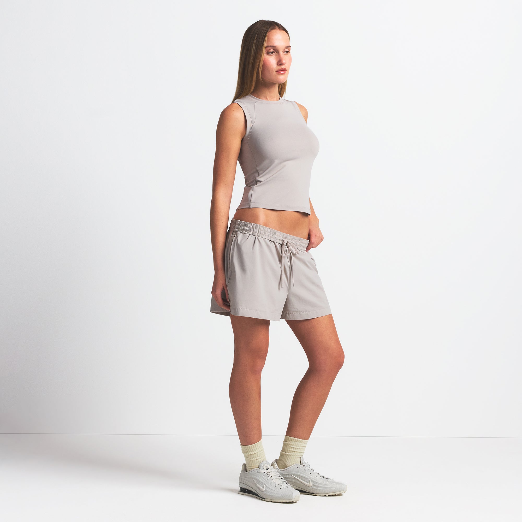 NikeSKIMS WOVEN NYLON 5" TRACK SHORT | STONE ON A MODEL SIDE VIEW @ | FOCUS: 0.0, 1.0, 0.9