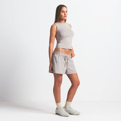 NikeSKIMS WOVEN NYLON 5" TRACK SHORT | STONE ON A MODEL SIDE VIEW @ | FOCUS: 0.0, 1.0, 0.9