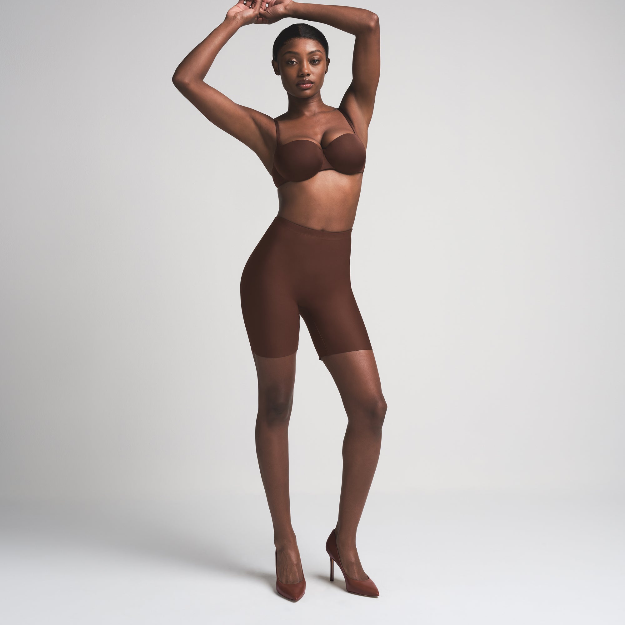SKIMS BODY BUTT ENHANCING PADDED SHORT | COCOA ON A MODEL FRONT VIEW