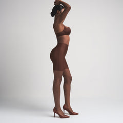 SKIMS BODY BUTT ENHANCING PADDED SHORT | COCOA ON A MODEL FRONT VIEW