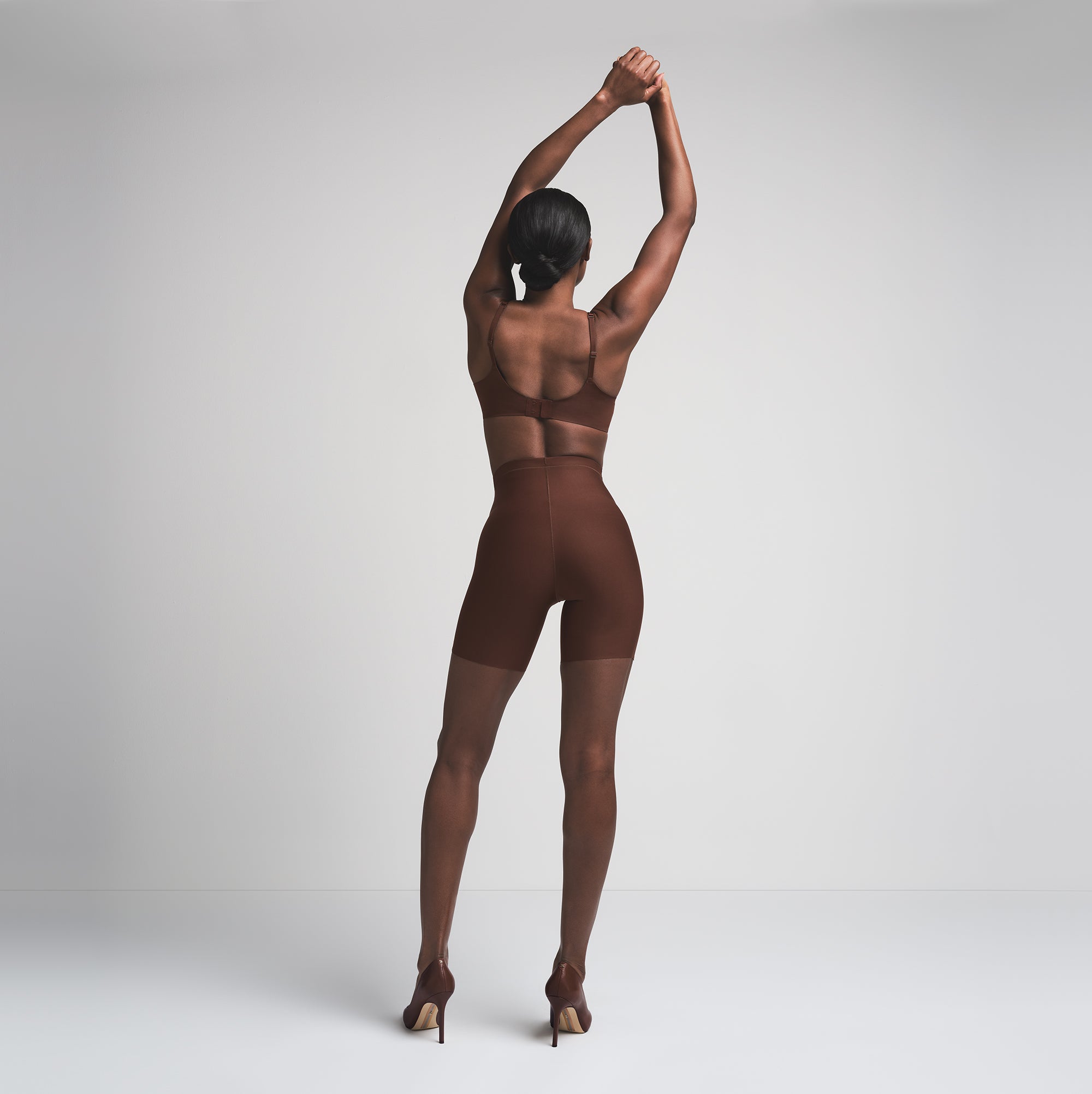 SKIMS BODY CORE SCULPT MID RISE SHORT | COCOA  ON A MODEL BACK VIEW