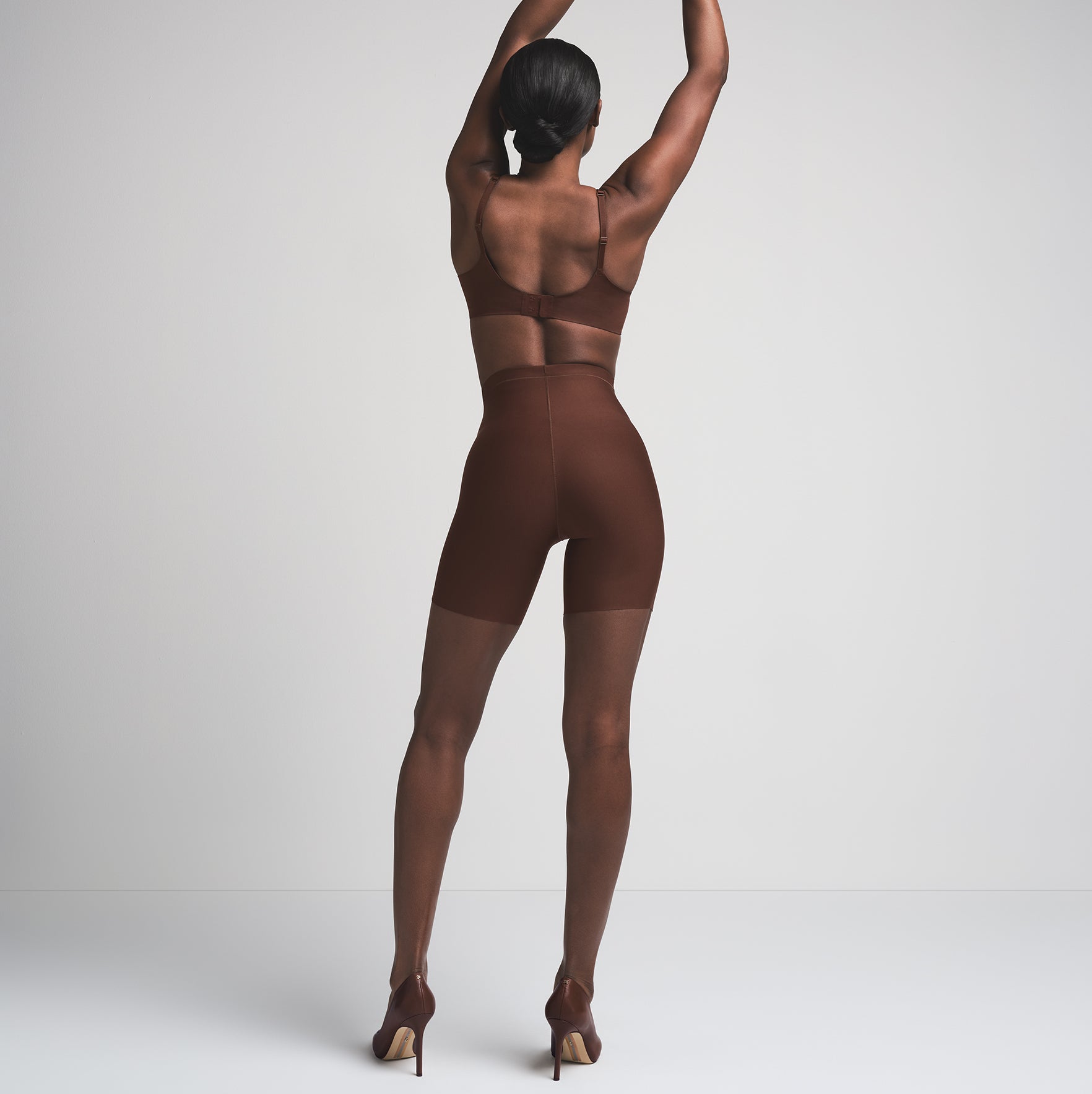SKIMS BODY CORE SCULPT MID RISE SHORT | COCOA  ON A MODEL BACK VIEW