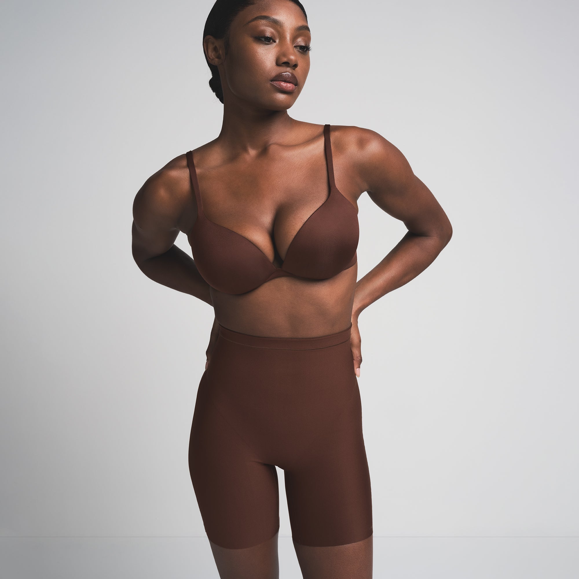 SKIMS BODY CORE SCULPT MID RISE SHORT | COCOA  ON A MODEL FRONT VIEW