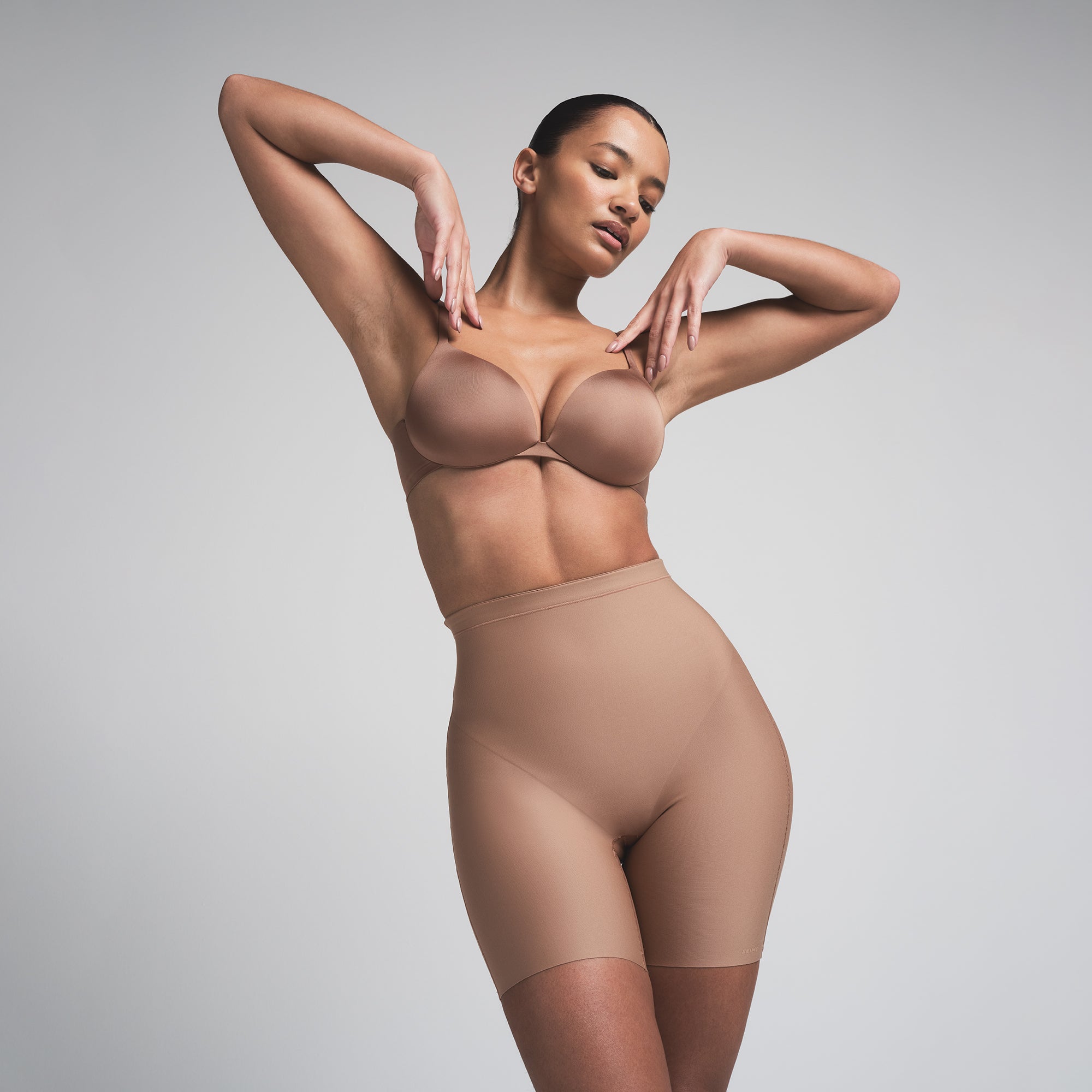 SKIMS BODY CORE SCULPT MID RISE SHORT | SIENNA  ON A MODEL FRONT VIEW