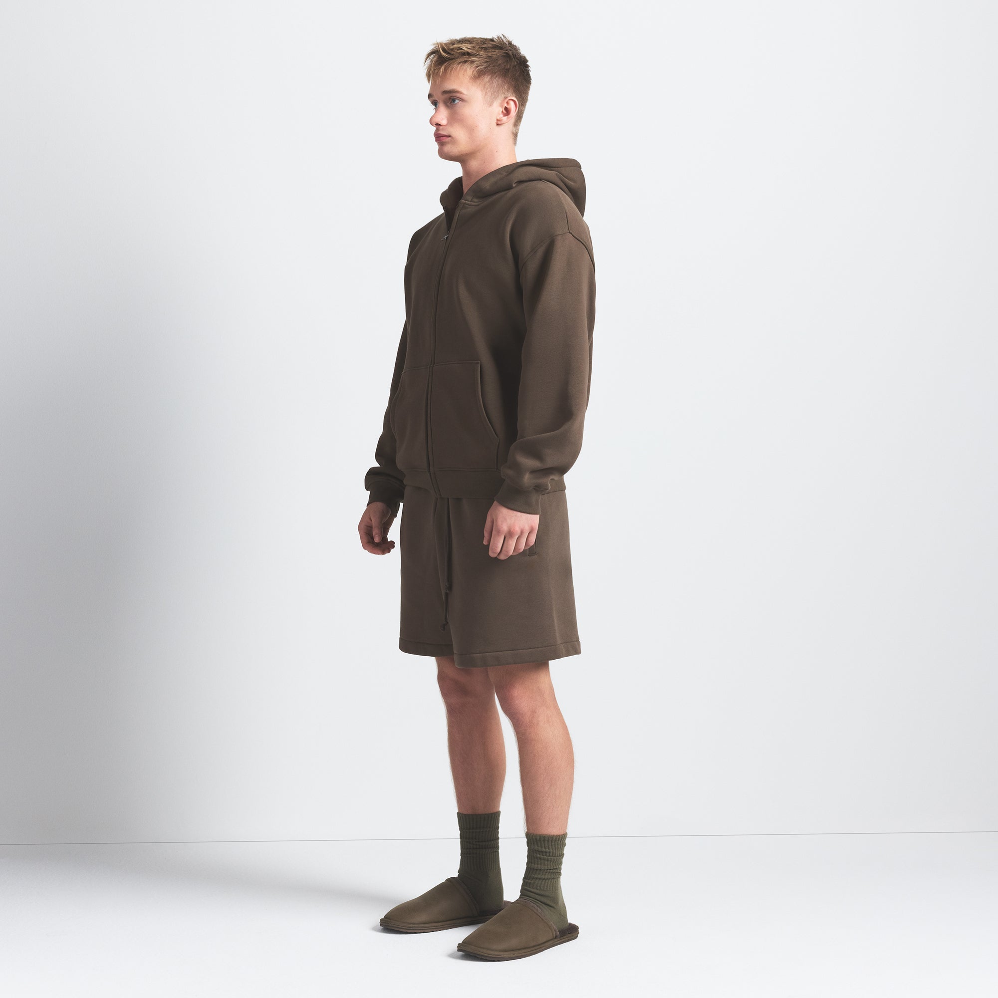 FLEECE LOUNGE MENS RELAXED SHORT | DRIFTWOOD ON A MODEL SIDE VIEW @ | FOCUS: 0.0, 1.0, 0.9
