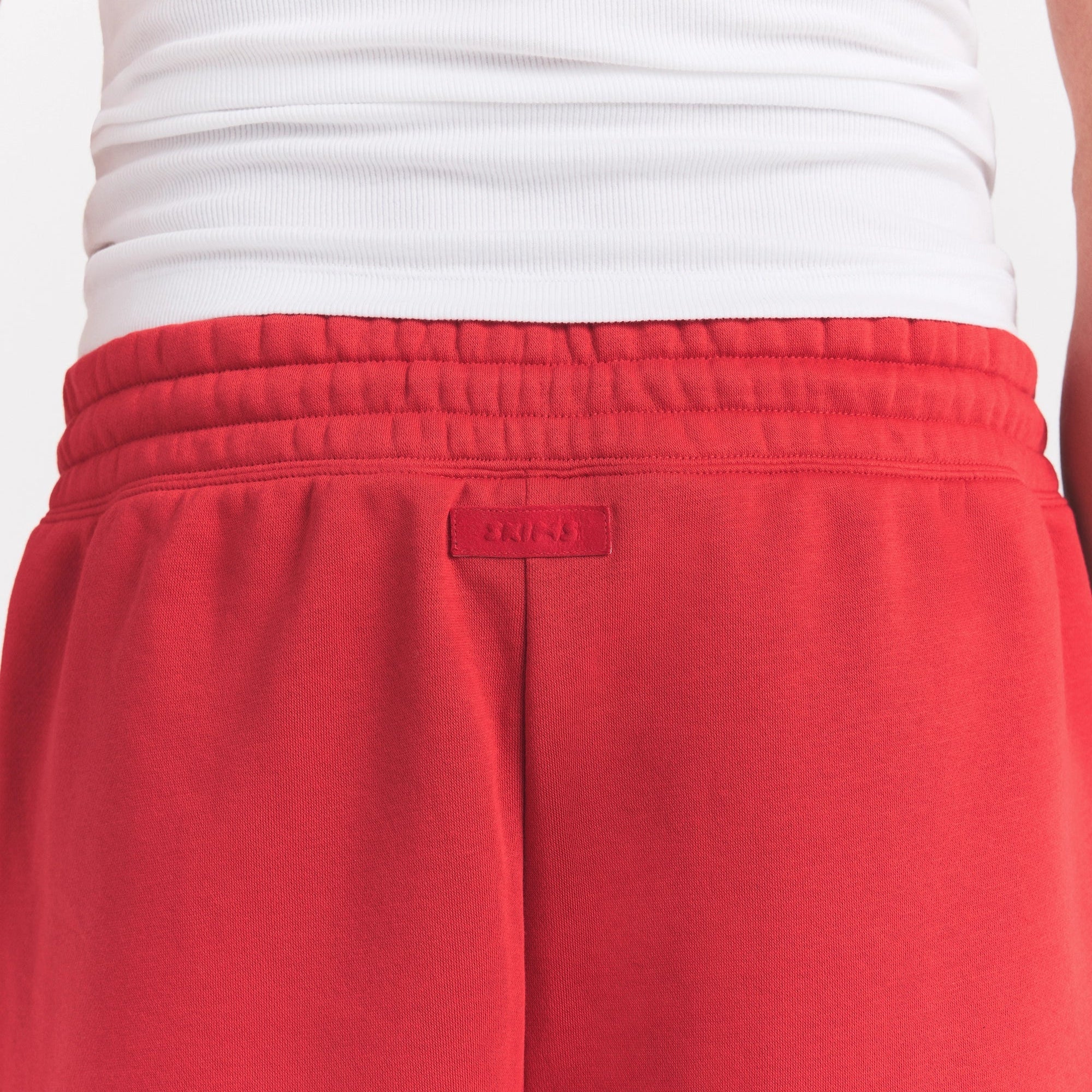 FLEECE LOUNGE MENS RELAXED SHORT | WASHED RED ON A MODEL SIDE VIEW @ | FOCUS: 0.0, 1.0, 0.9