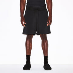 FLEECE LOUNGE MENS RELAXED SHORT | WASHED ONYX ON A MODEL SIDE VIEW @ | FOCUS: 0.0, 1.0, 0.9