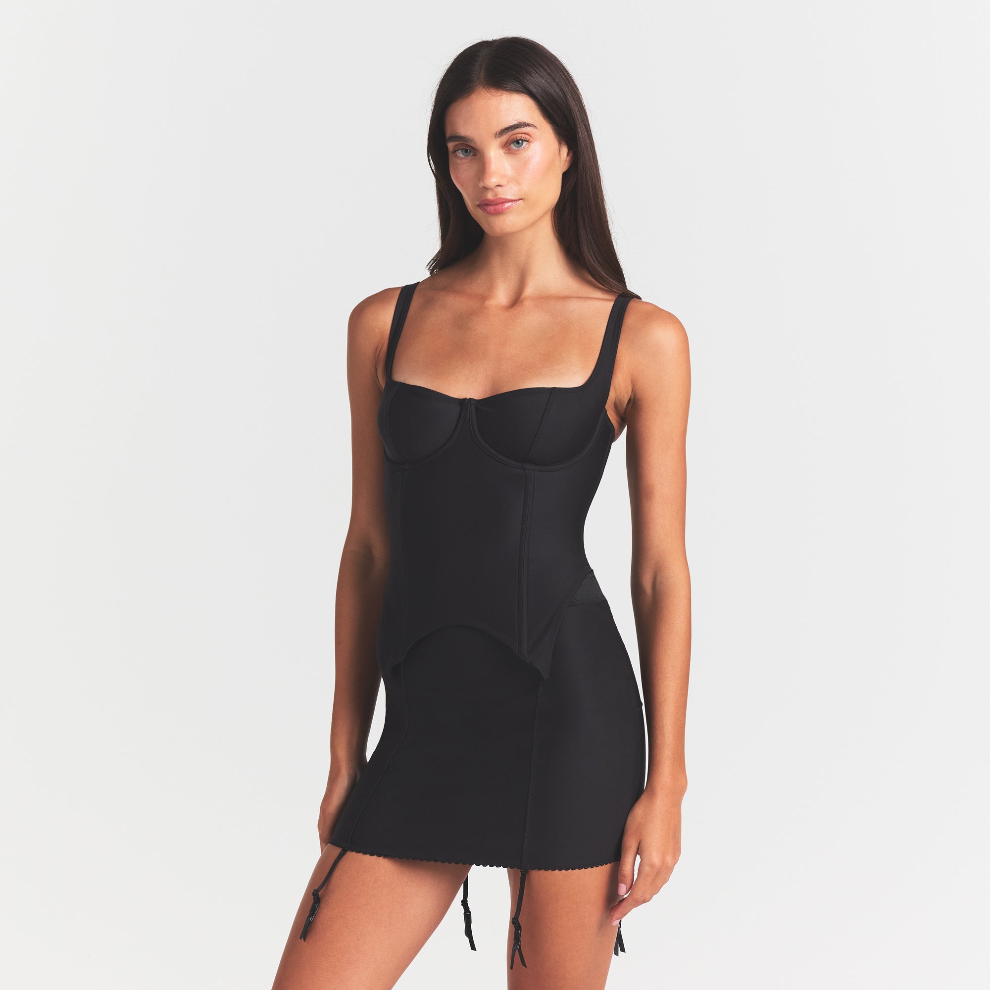 SKIMS BODY MINI GARTER SKIRT | ONYX ON A MODEL SIDE VIEW @