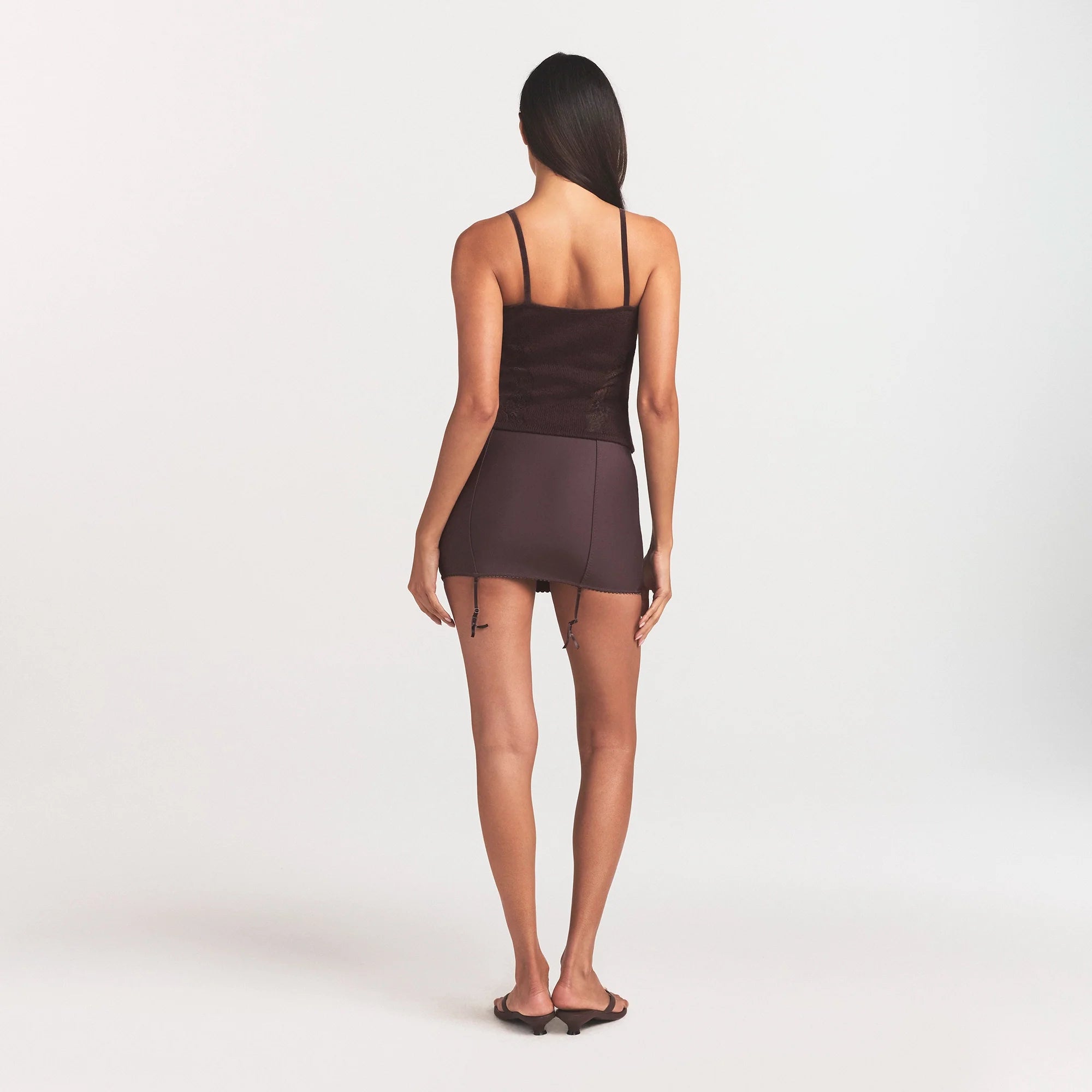 SKIMS BODY MINI GARTER SKIRT | RAISIN ON A MODEL SIDE VIEW @