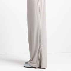 NikeSKIMS WOVEN NYLON OVERSIZED TRACK PANT | STONE ON A MODEL SIDE VIEW @ | FOCUS: 0.0, 1.0, 0.9