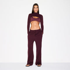 NikeSKIMS MATTE TRICOT SIDE SNAPS PANT | CURRANT ON A MODEL FRONT VIEW @ | FOCUS: 0.0, 1.0, 0.9