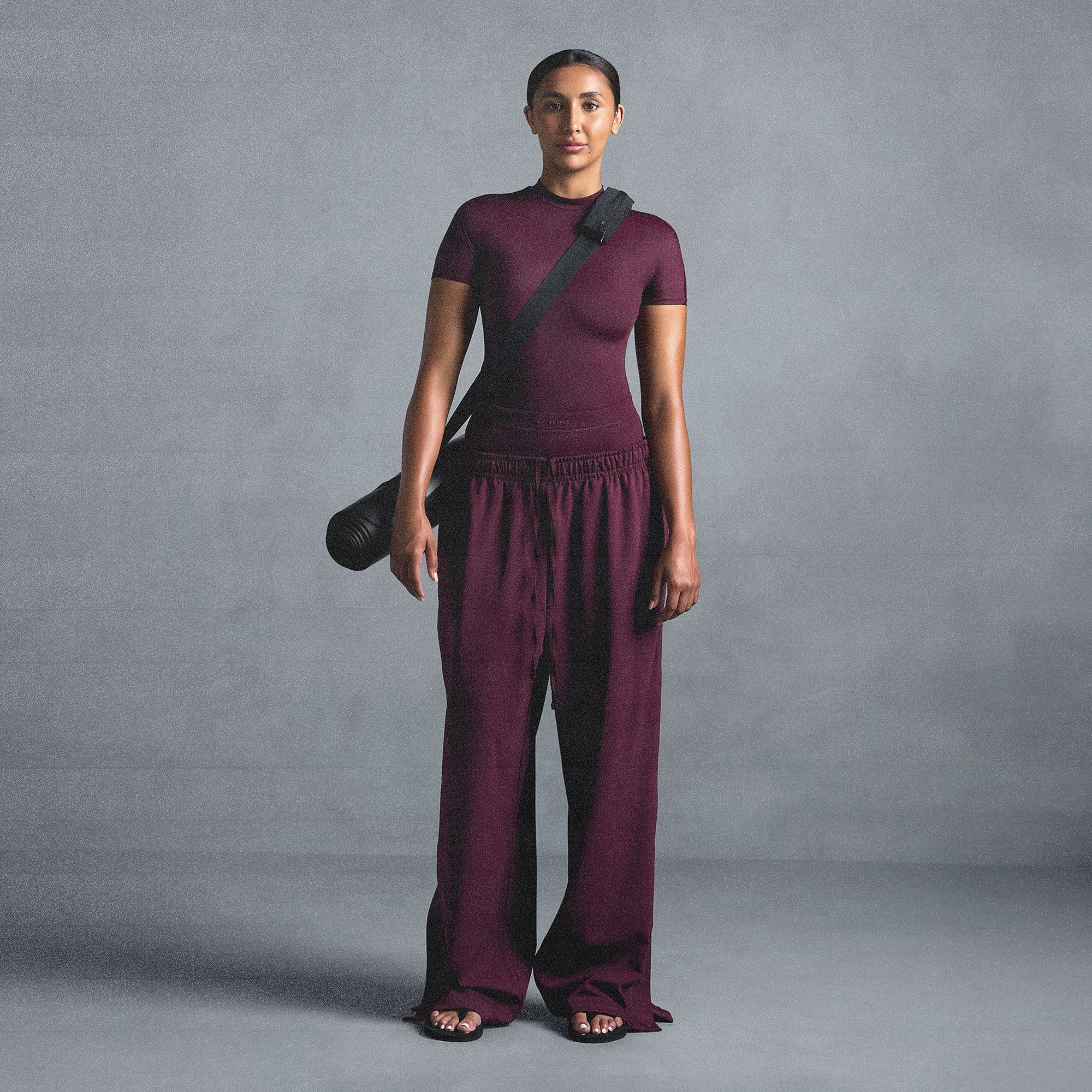 NikeSKIMS MATTE TRICOT SIDE SNAPS PANT | CURRANT ON A MODEL SIDE VIEW @ | FOCUS: 0.0, 1.0, 0.9