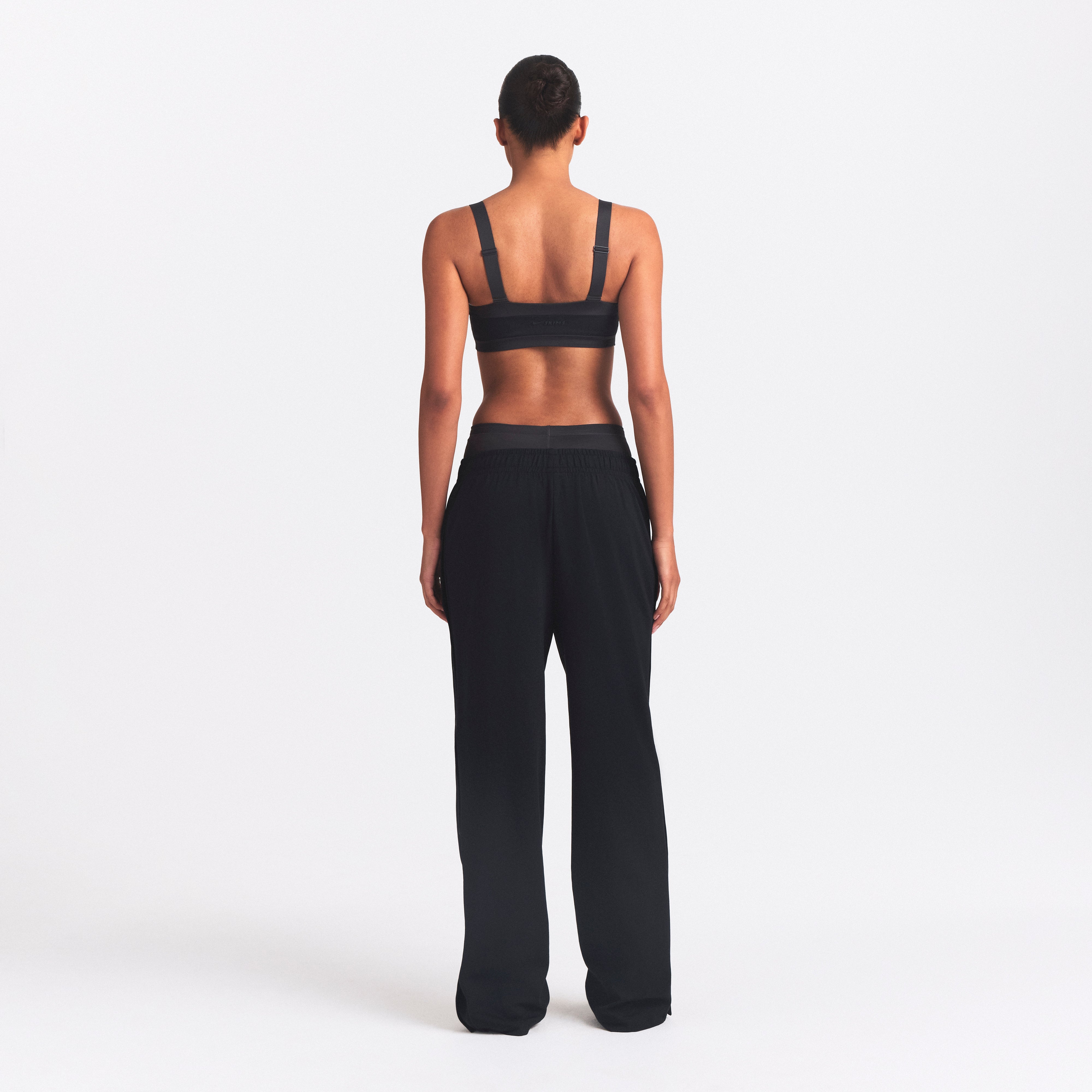 NikeSKIMS MATTE TRICOT SIDE SNAPS PANT | OBSIDIAN ON A MODEL SIDE VIEW @ | FOCUS: 0.0, 1.0, 0.9