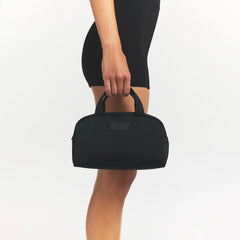 SKIMS ACCESSORIES SATIN MINI DUFFLE BAG | ONYX ON A MODEL SIDE VIEW