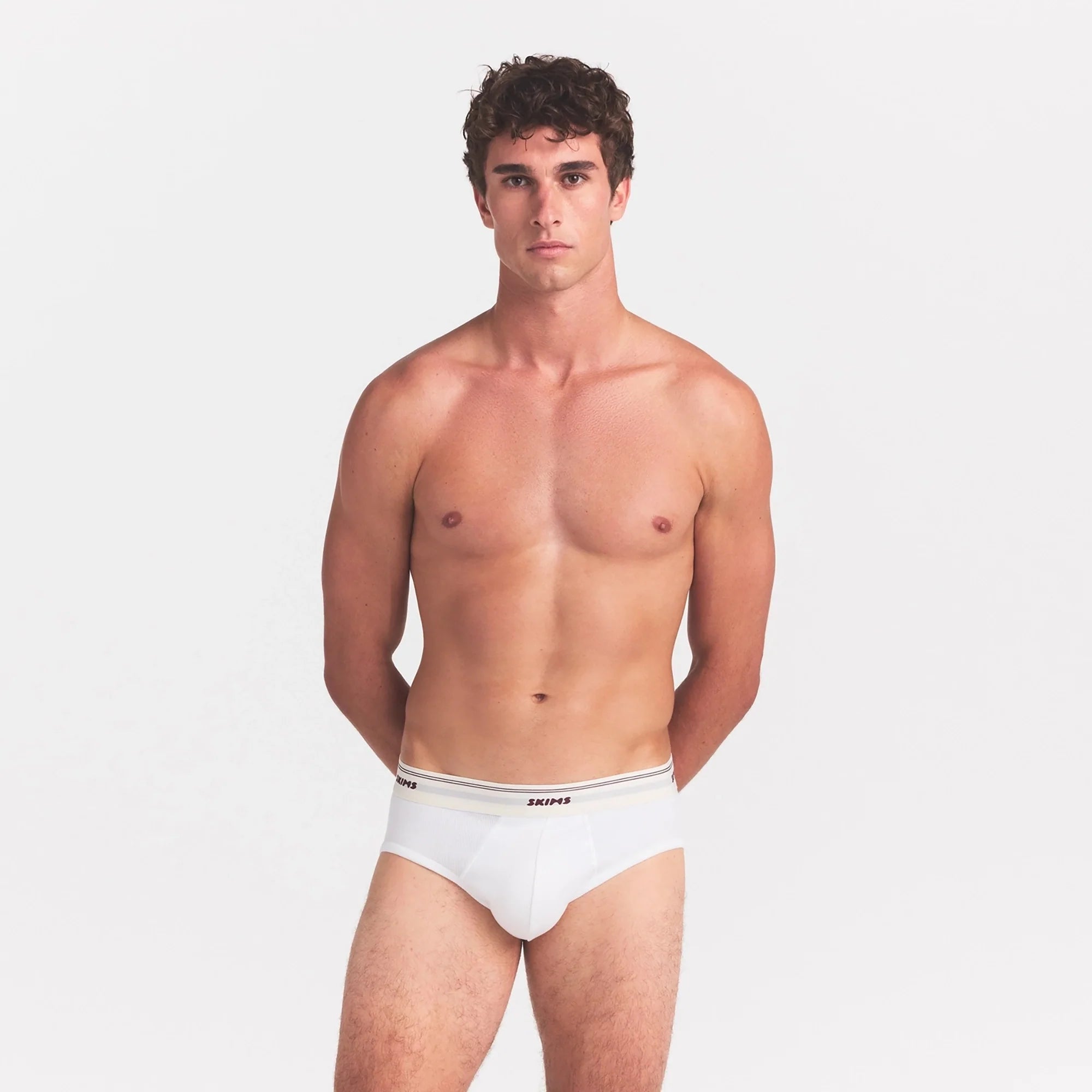 SKIMS COTTON RIB MENS BRIEF | CHALK ON A MODEL SIDE VIEW @ | FOCUS: 0.0, 1.0, 0.9