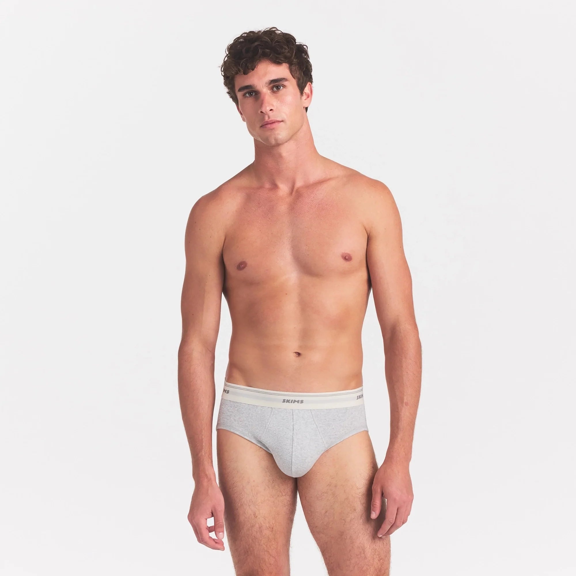 SKIMS COTTON RIB MENS BRIEF | LIGHT HEATHER GREY ON A MODEL SIDE VIEW @ | FOCUS: 0.0, 1.0, 0.9