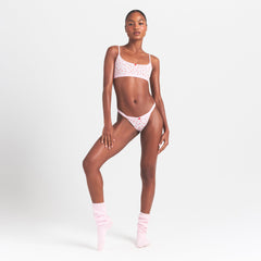 LIGHTWEIGHT COTTON LOGO PICOT SCOOP BRALETTE | BABY PINK ARROWED HEARTS ON A MODEL FRONT VIEW @ | FOCUS: 0.0, 1.0, 0.9